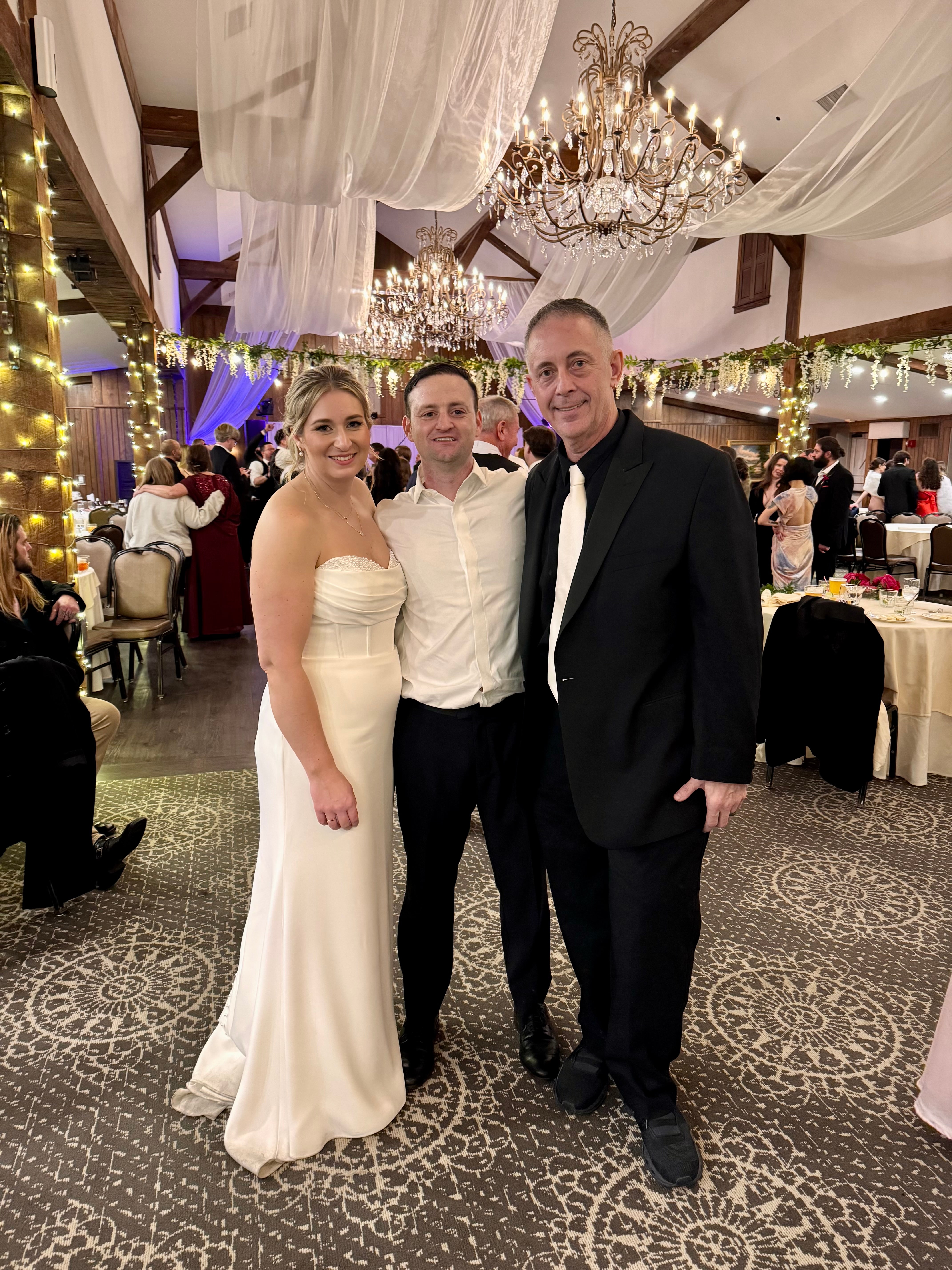 Franco celebrating with newlyweds at their wedding reception
