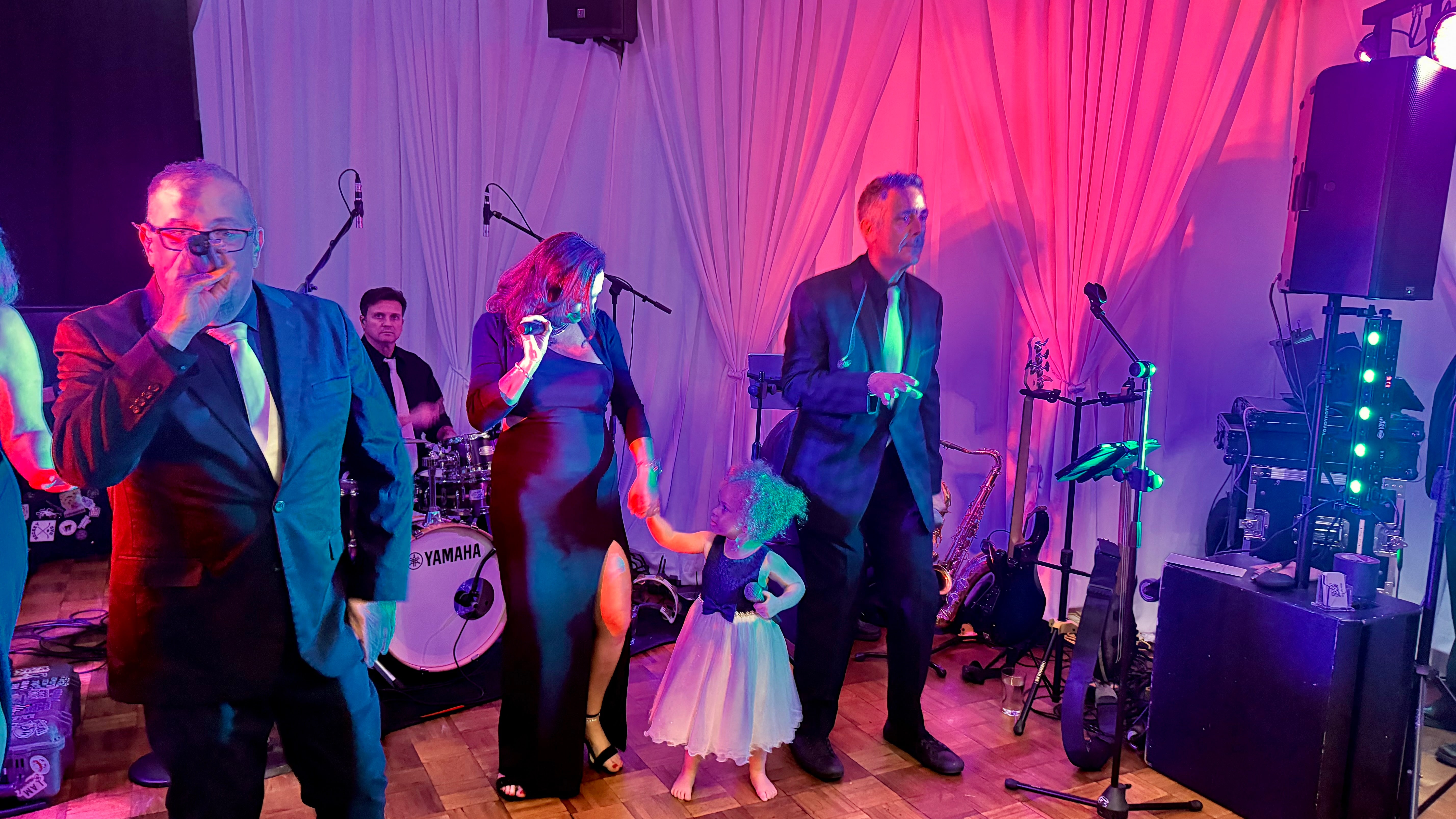 Bigg Romeo performing with a young wedding guest on the dance floor