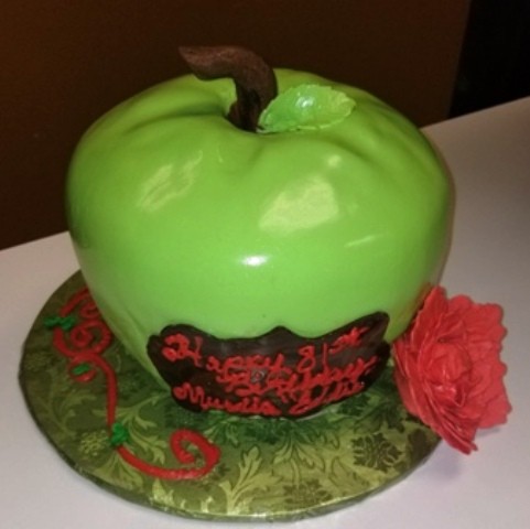 Green apple-shaped birthday cake with a red flower