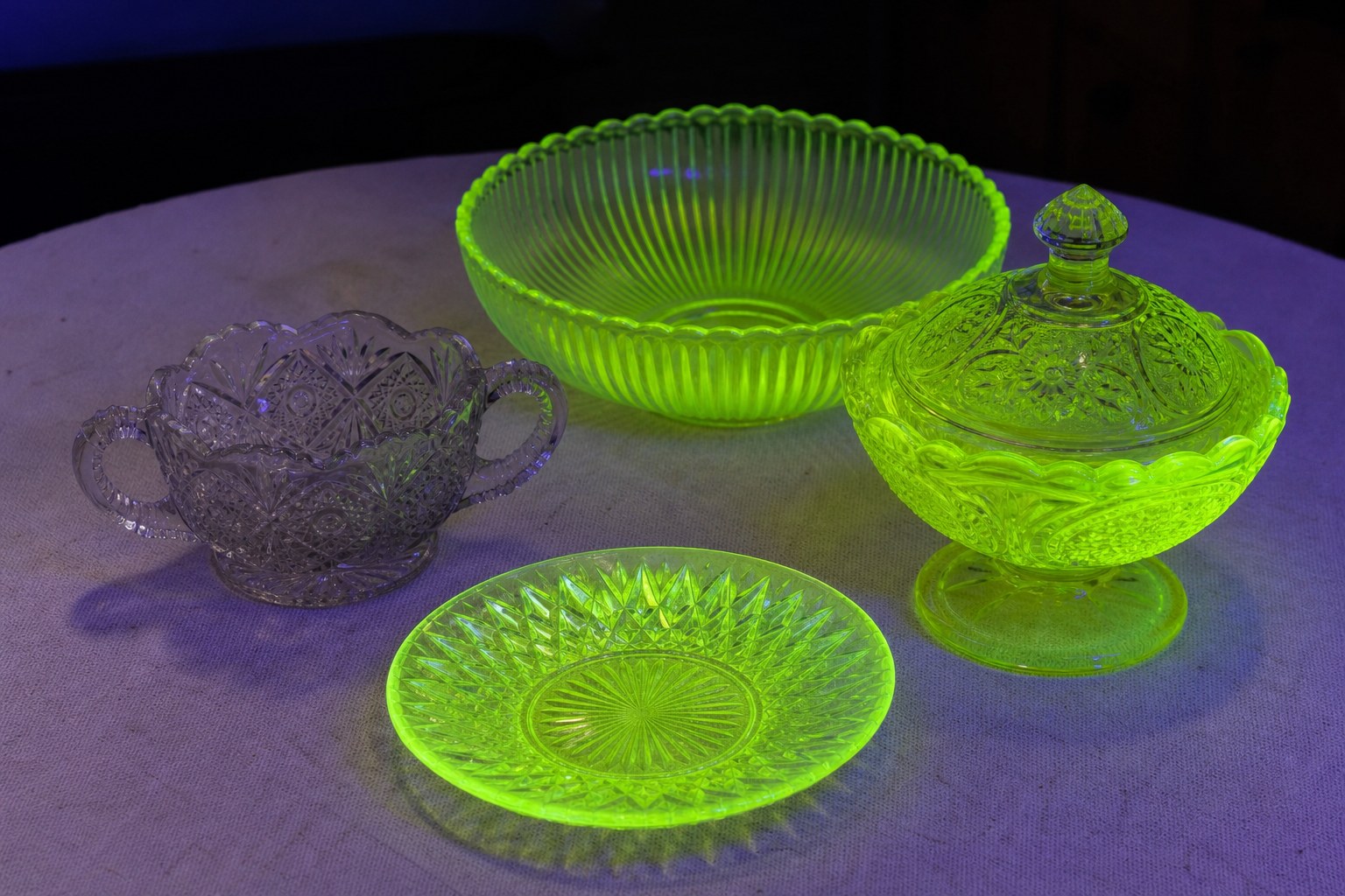 Vintage pressed glass glowing yellow-green under ultraviolet light