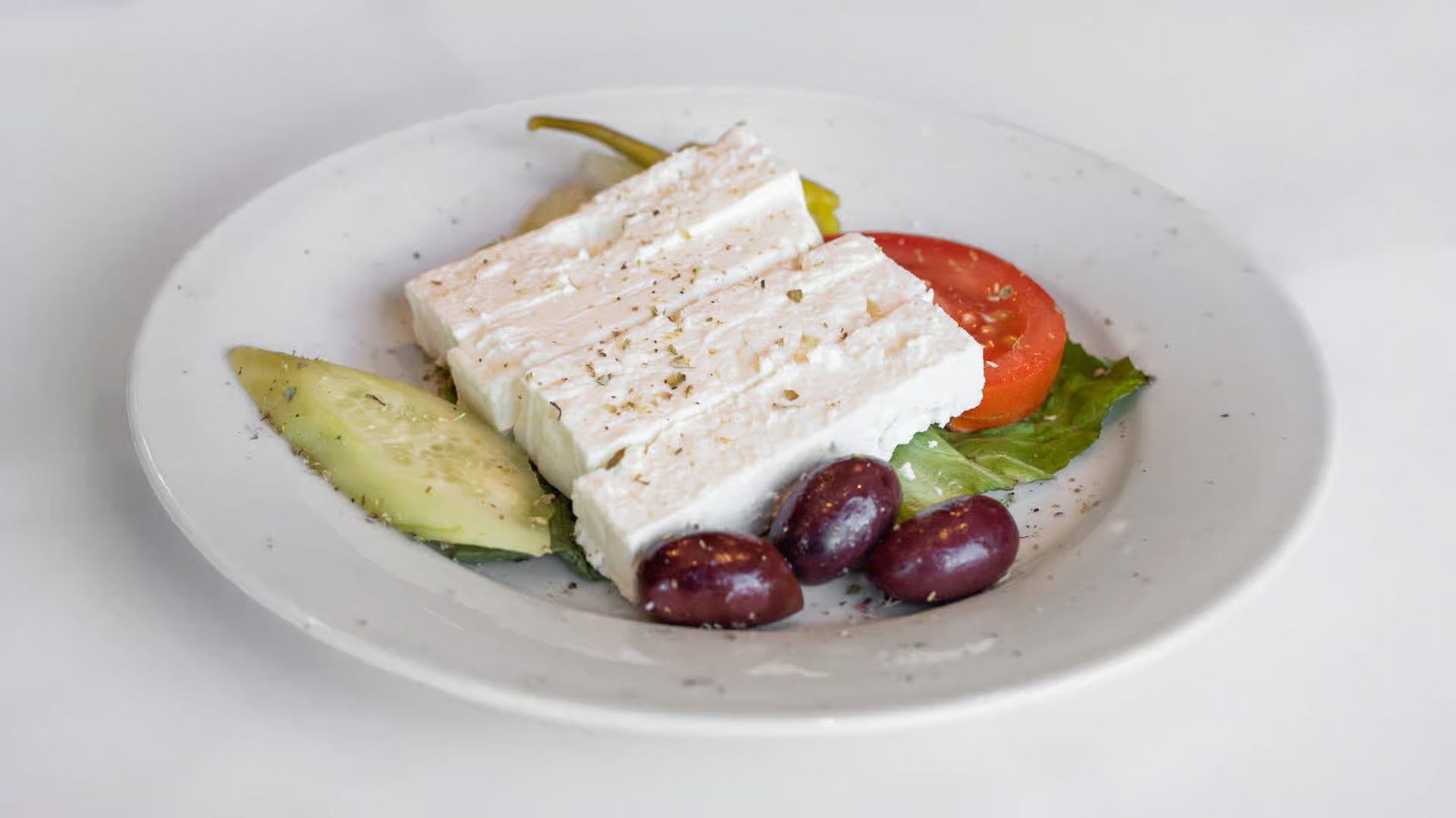 Feta and Greek meze served on a small plate