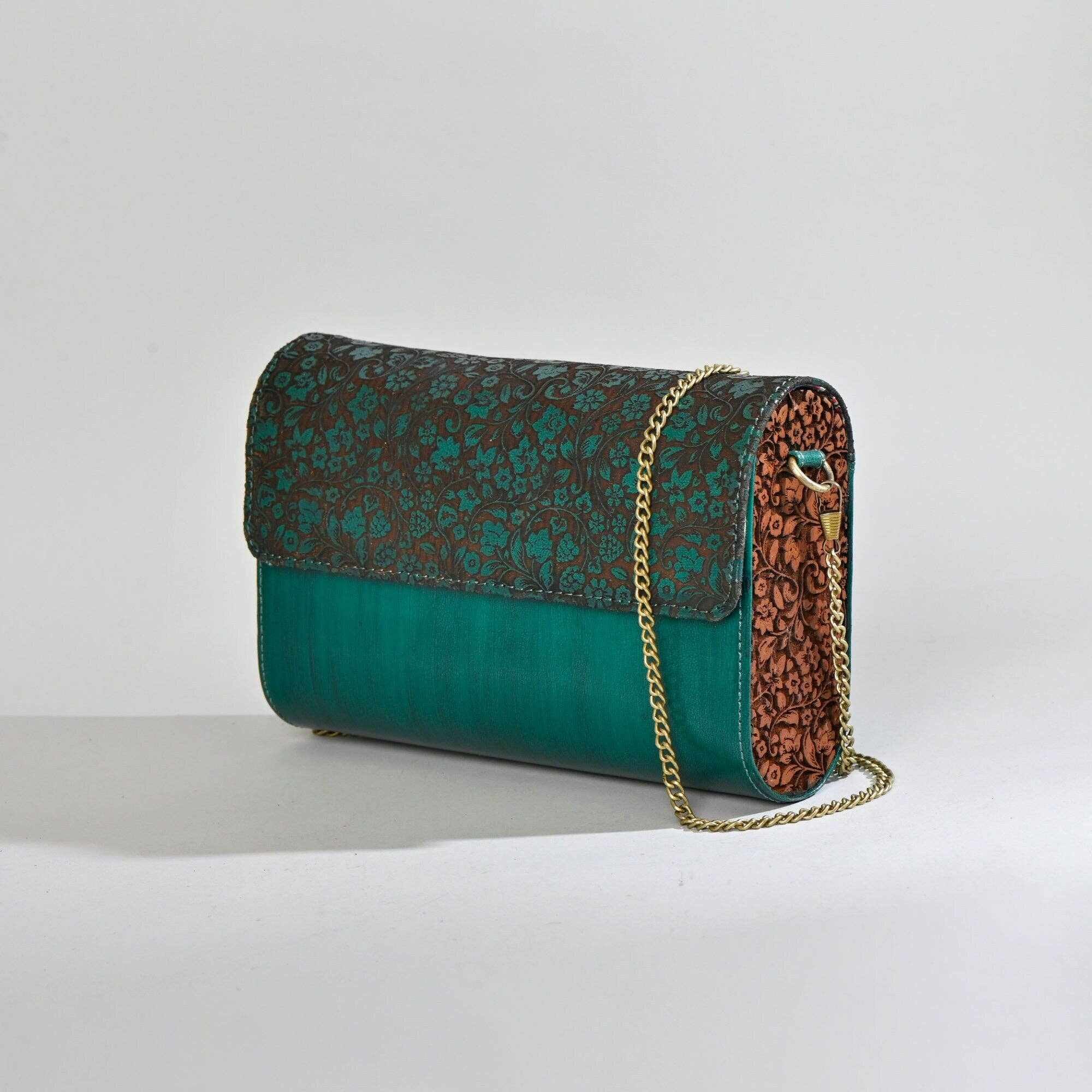 An emerald green leather clutch with etched detail