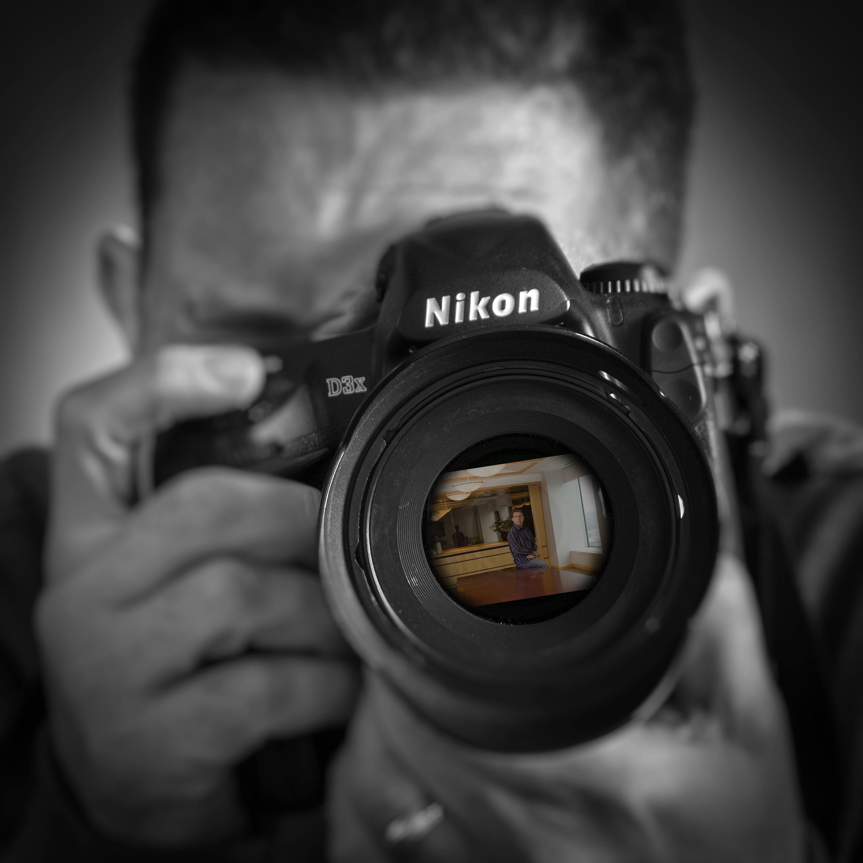 Howard Tucker holding a Nikon camera