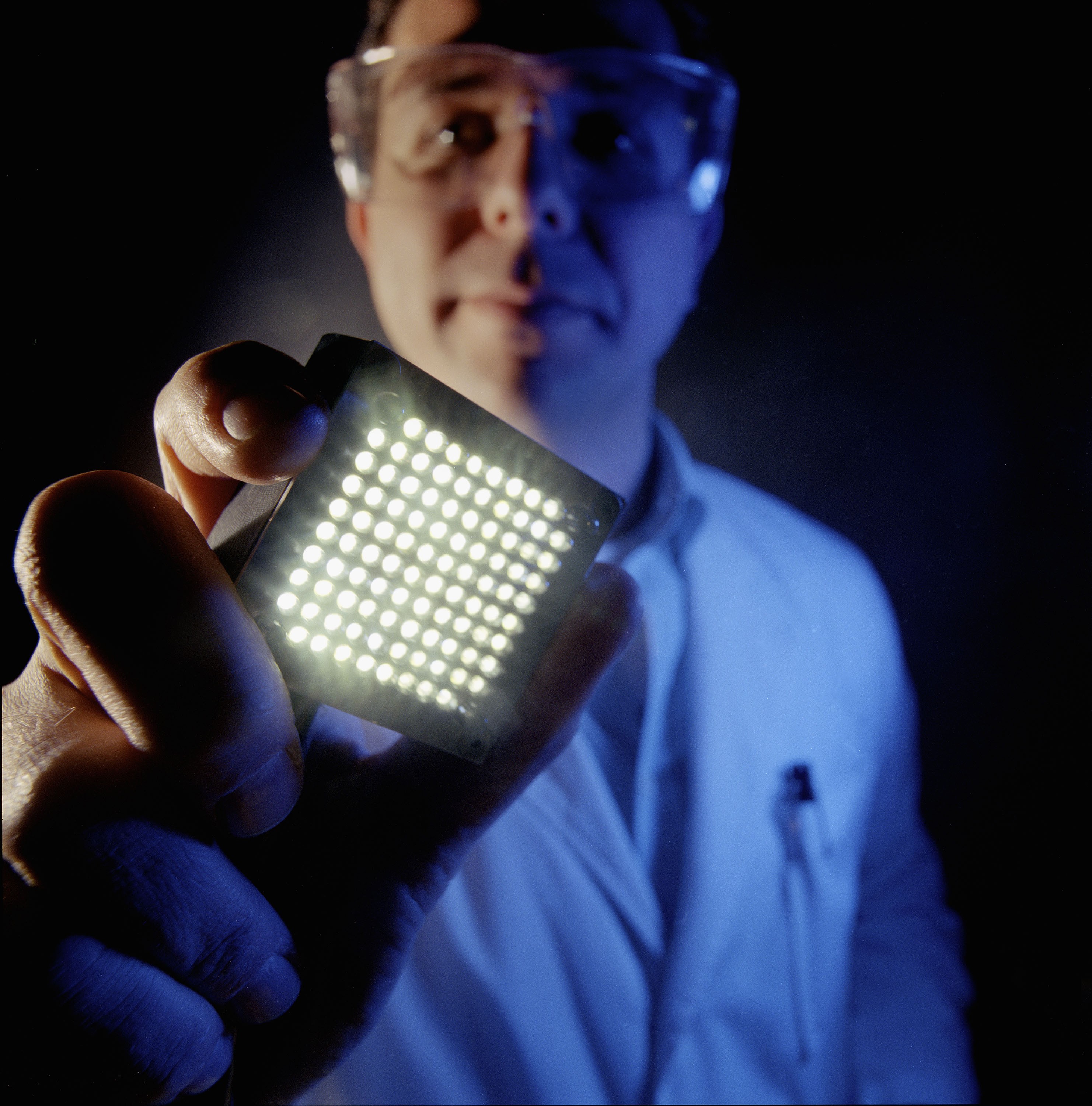 Portrait of a person holding a light