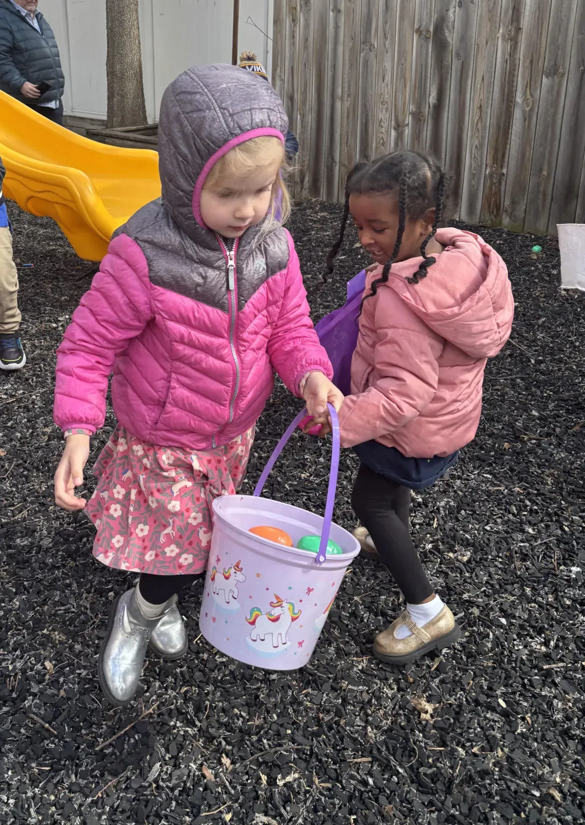 Young children playing together outdoors at Seeds of Wisdom