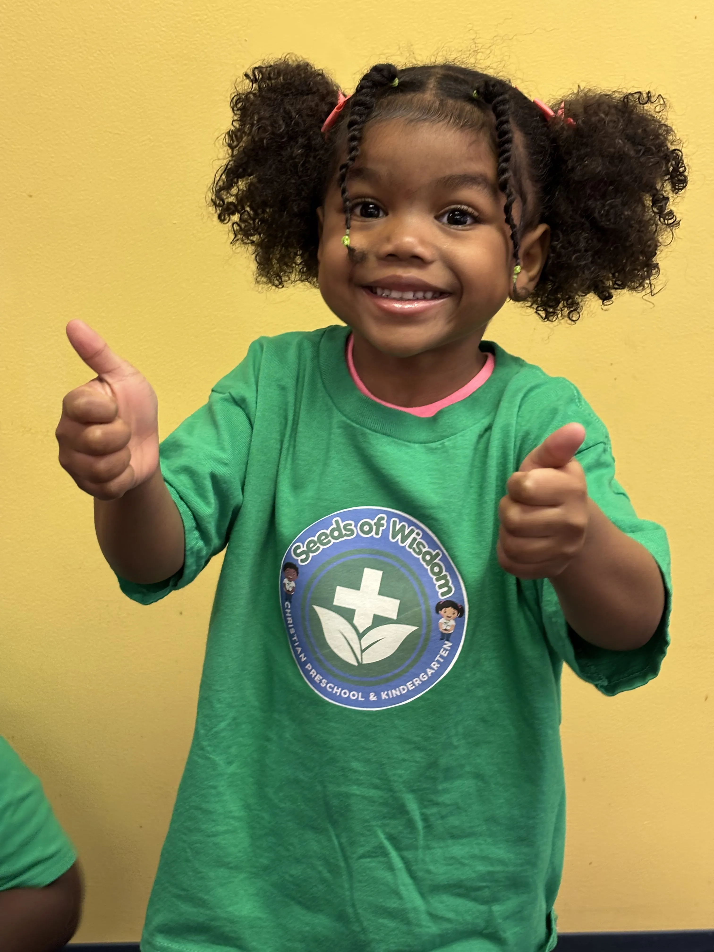 A smiling child at Seeds of Wisdom