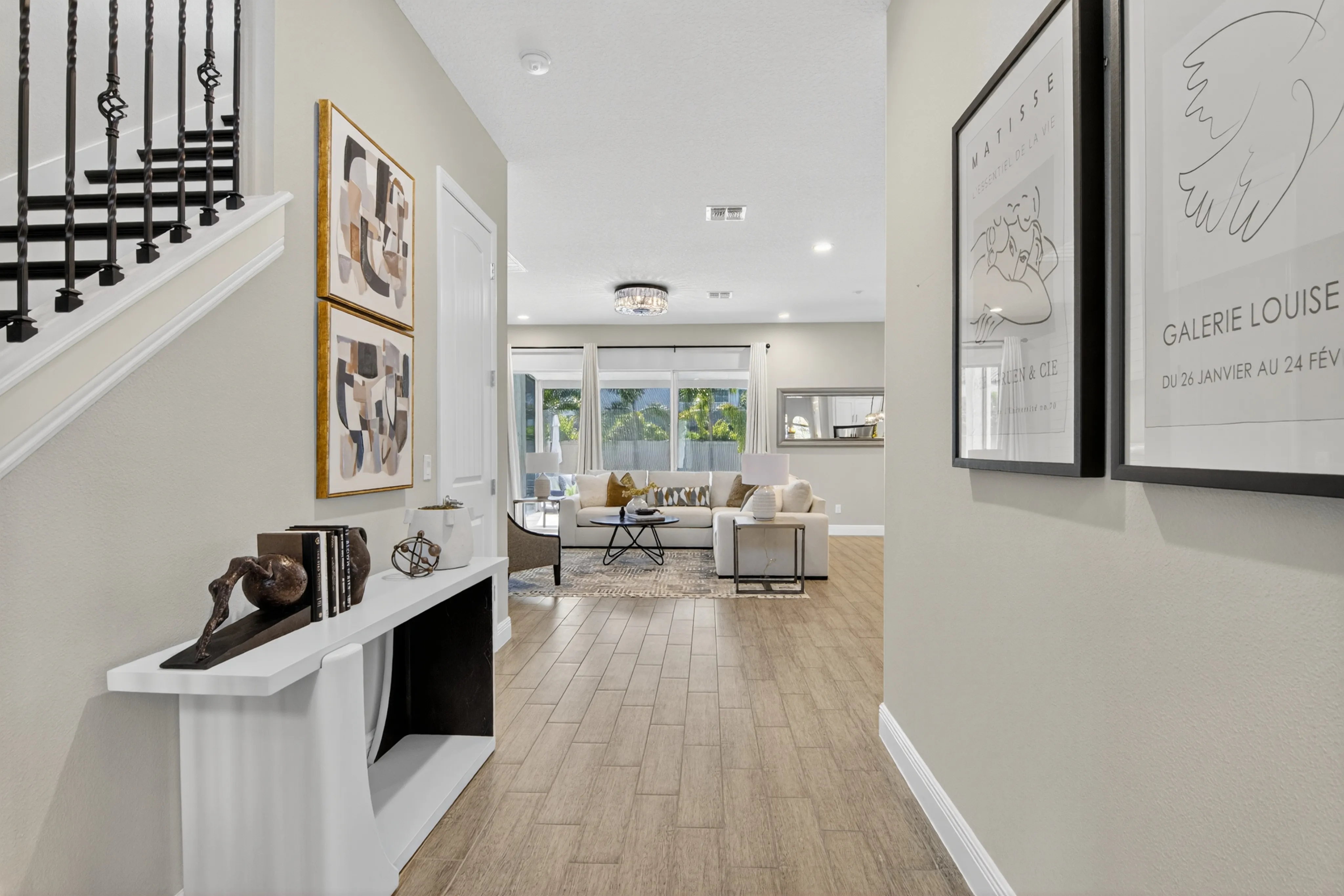 Staged home entry leading to a furnished living space