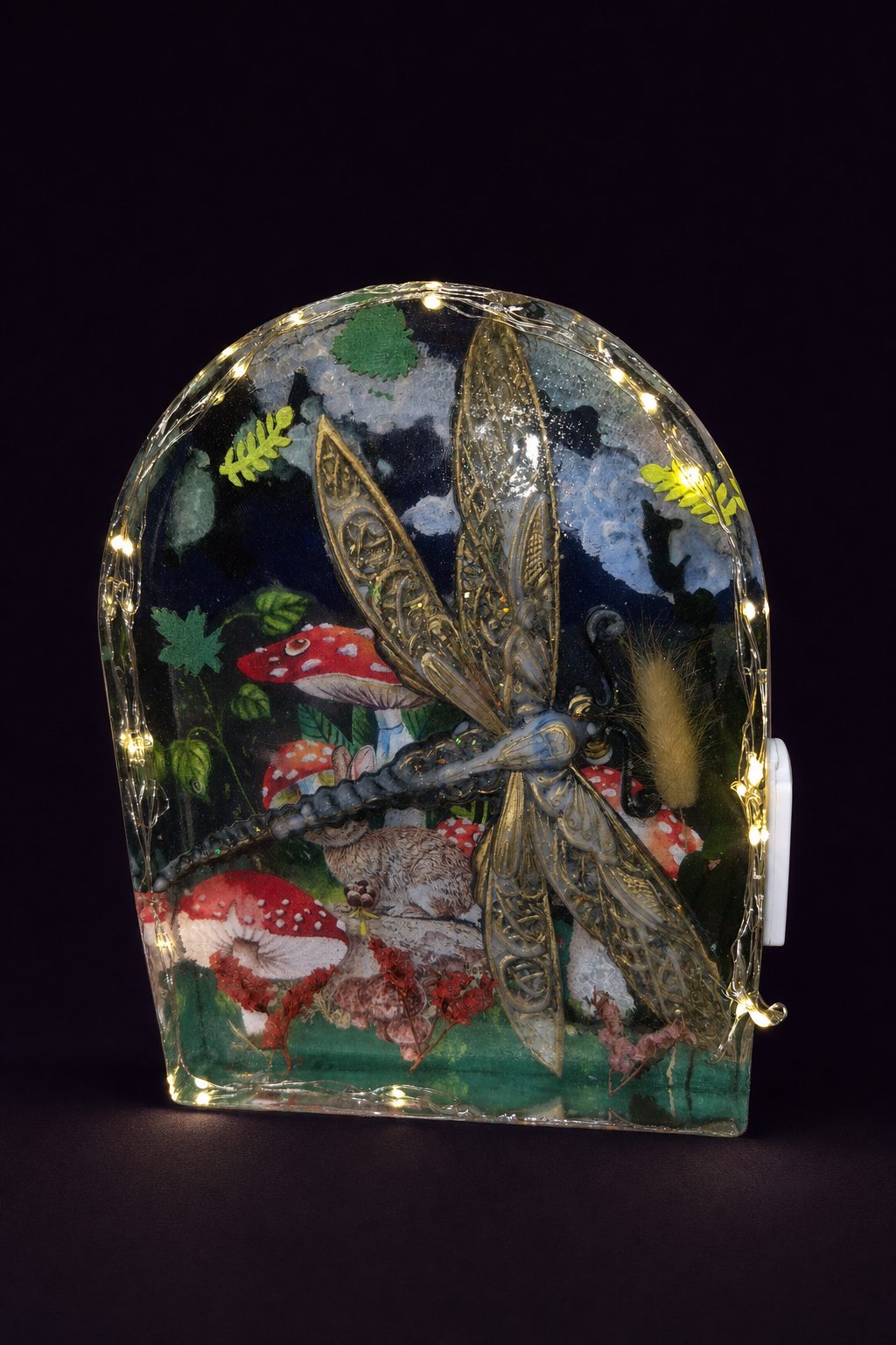 Dragonfly still life nightlight illuminated around a woodland scene with mushrooms and a rabbit