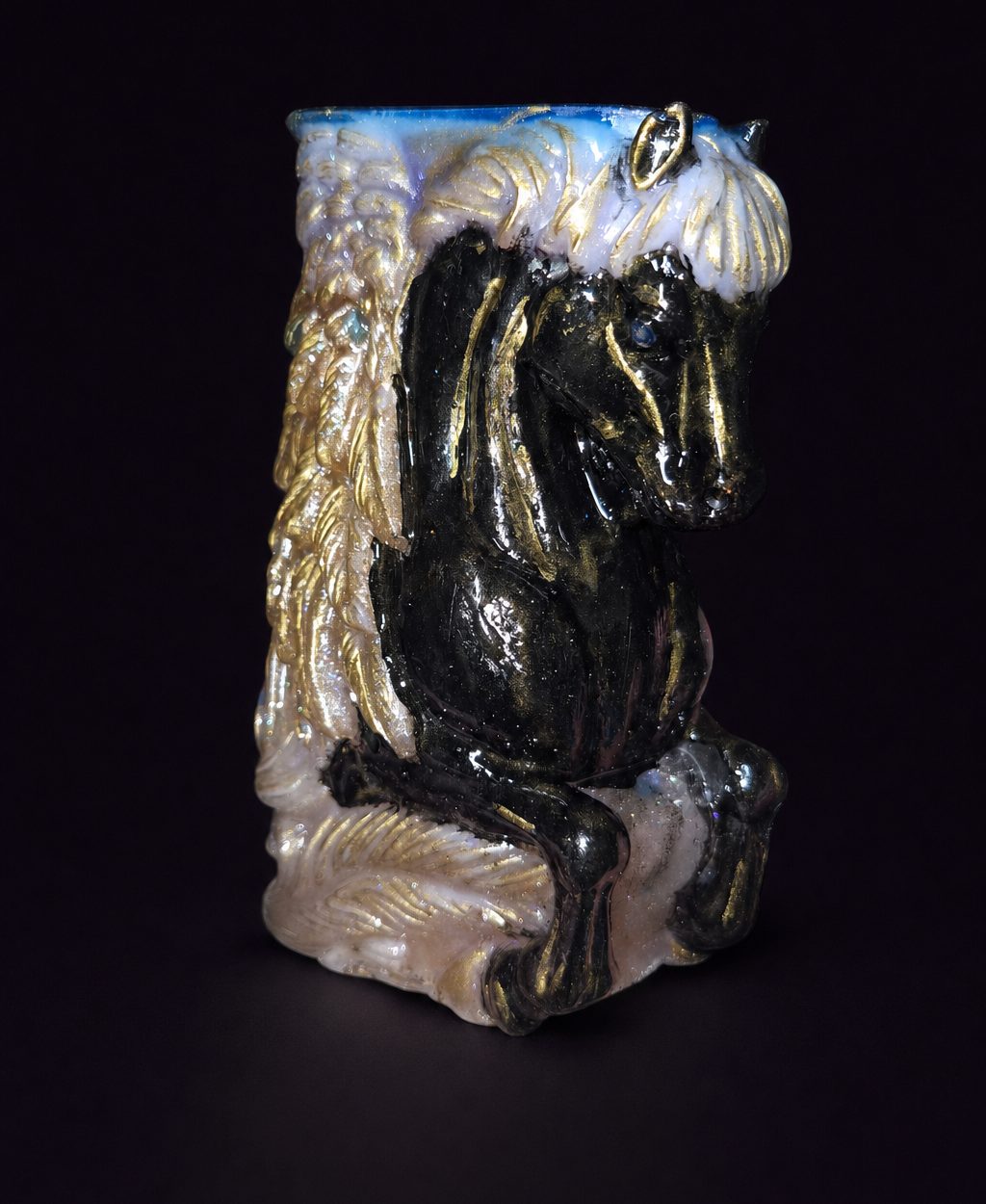 Front view of the hand-painted resin Pegasus with blue rhinestone eyes and gold chrome accents