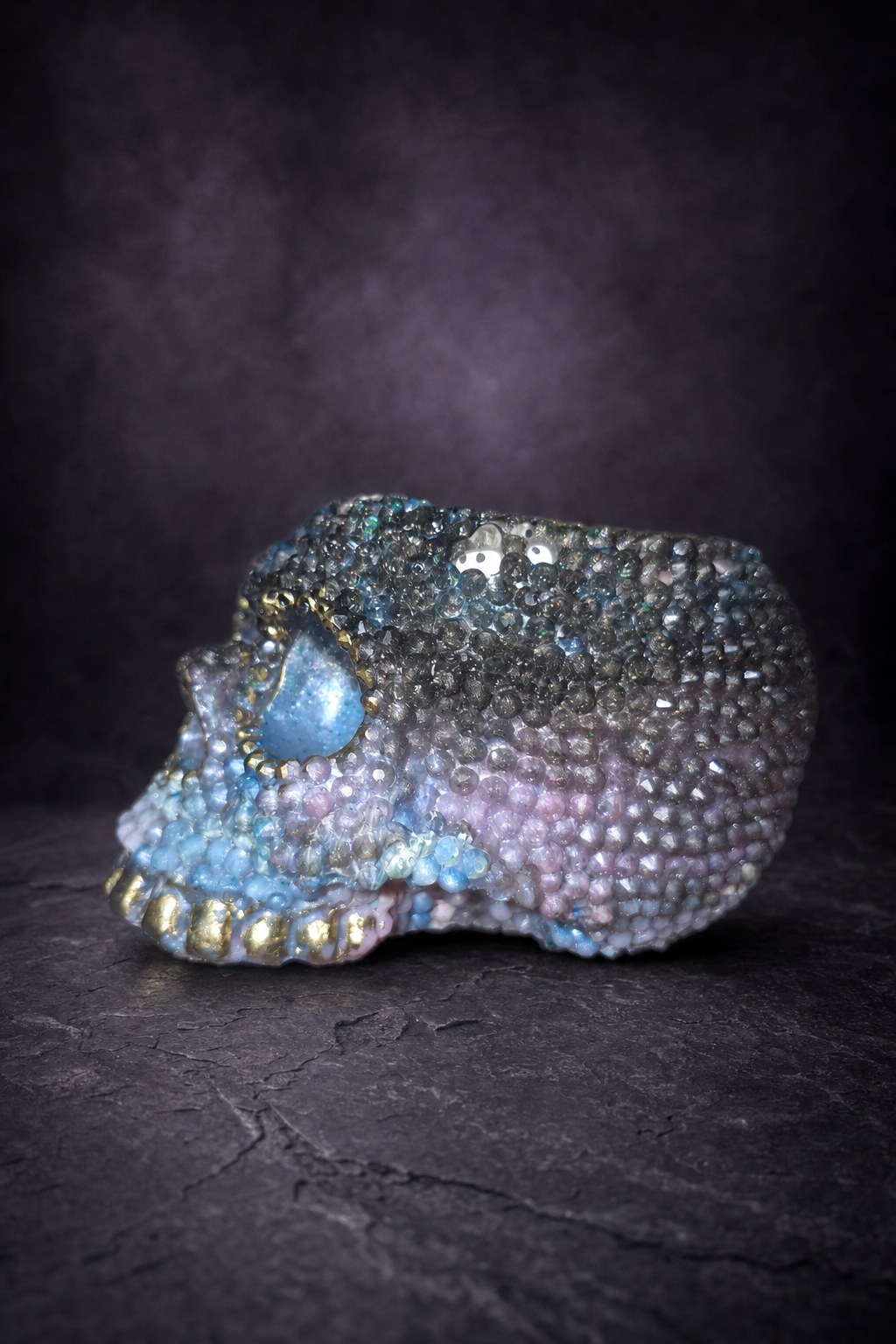 Opposite side of a skull candle holder showing the faceted surface and tiny bats