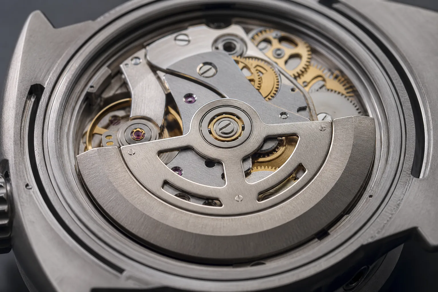 Close view of an automatic watch rotor and the gears beneath it