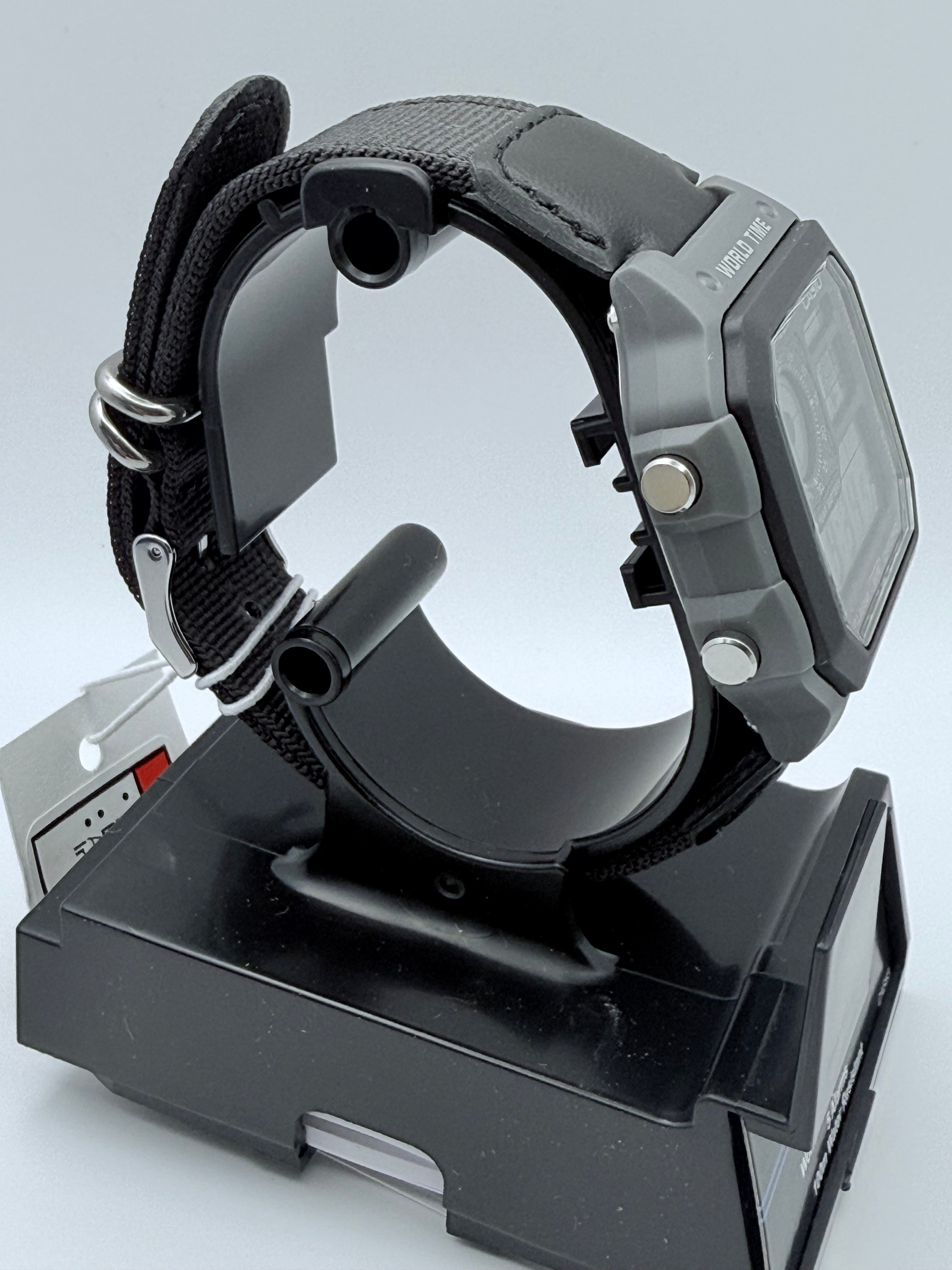 Side view of the Casio AE1200 case, four buttons, and black fabric strap