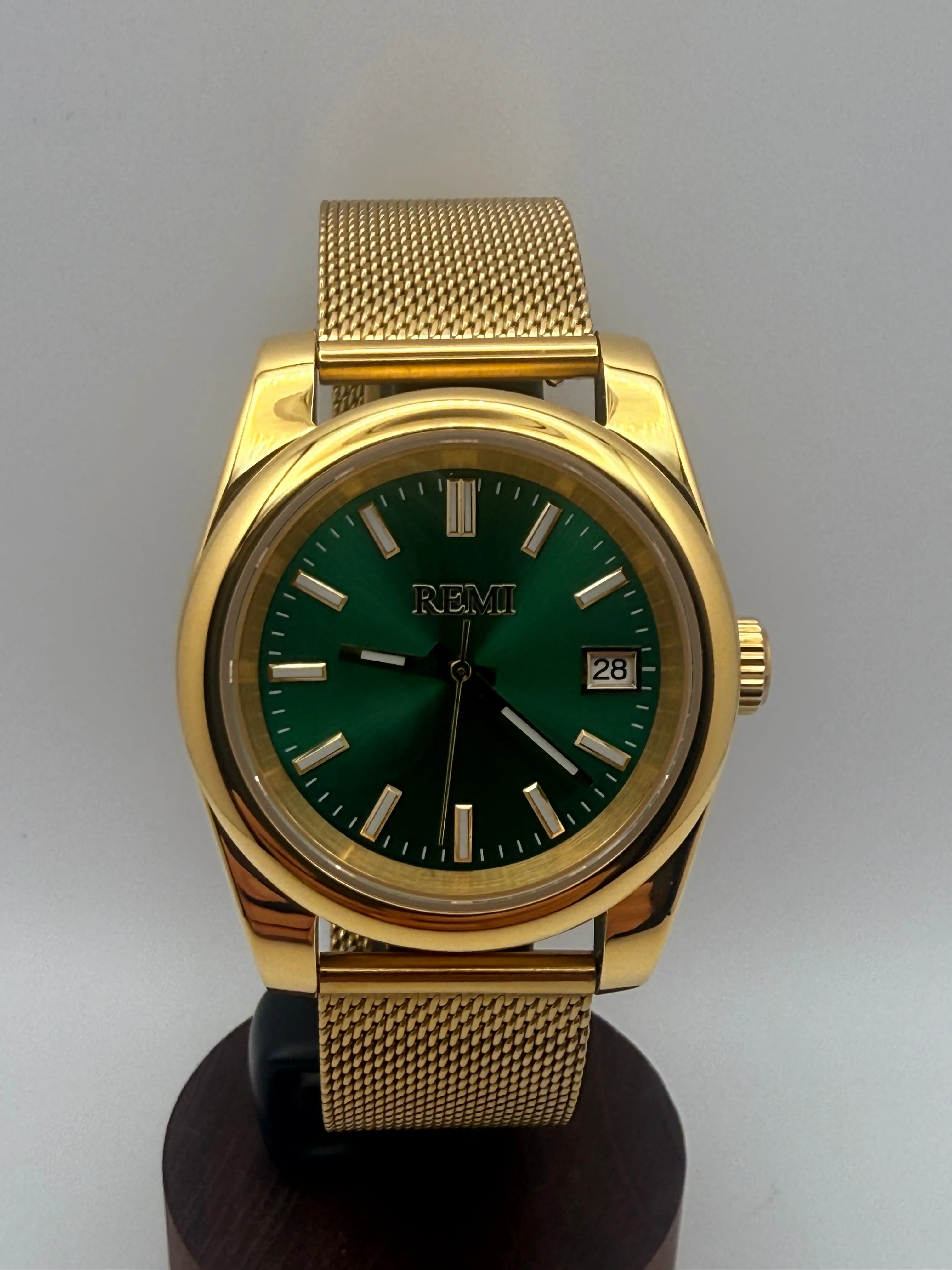 REMI Monarch Dress green dial watch on a gold-tone stainless steel bracelet