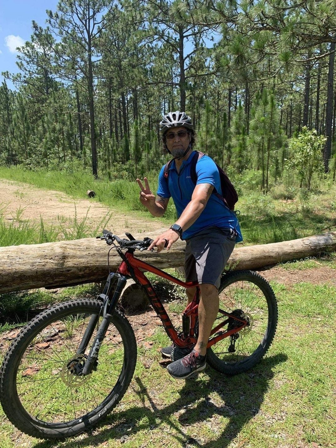 BJ Patterson riding a mountain bike through pine woods