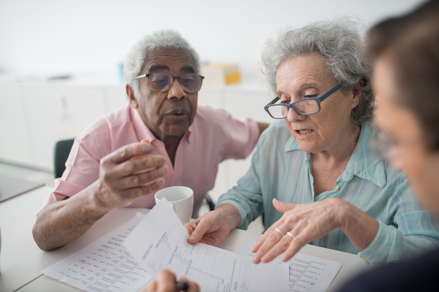 Older couple discussing paperwork with an advisor