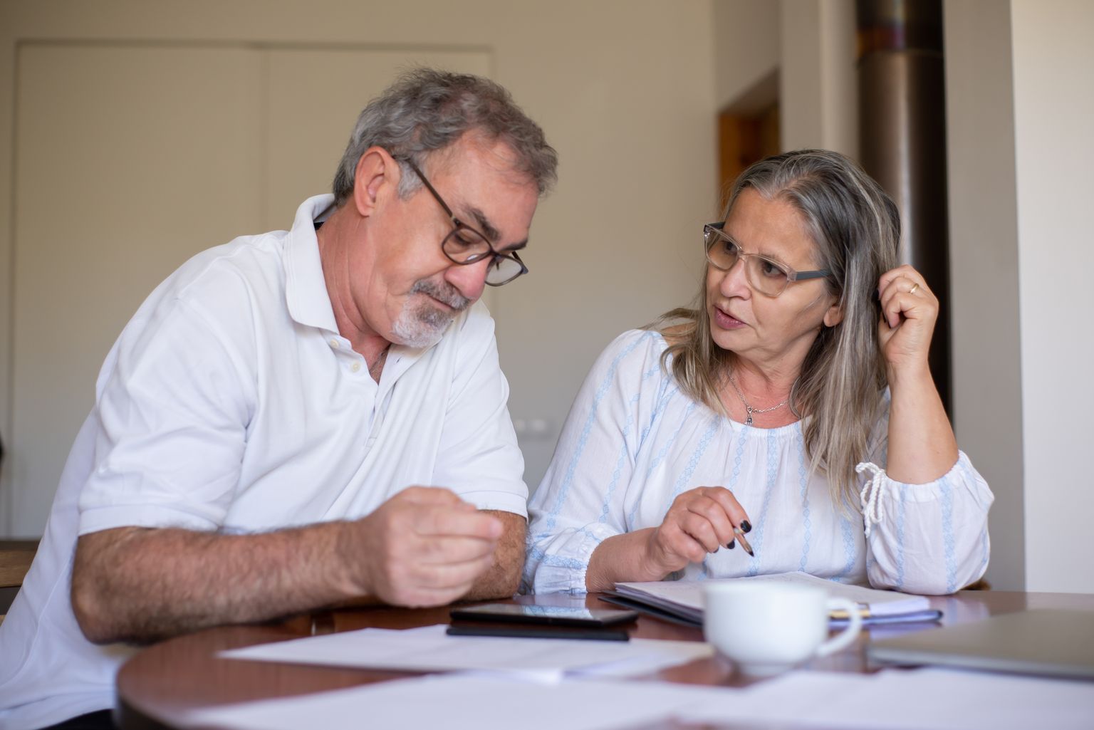 Older couple reviewing documents together at home