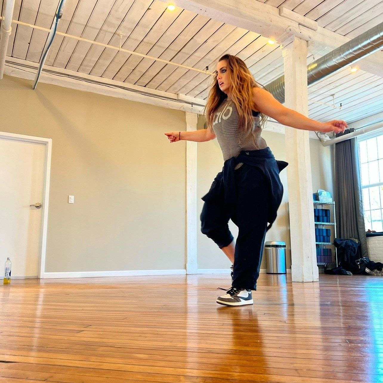 Becky Forbes moving with energy in a fitness class
