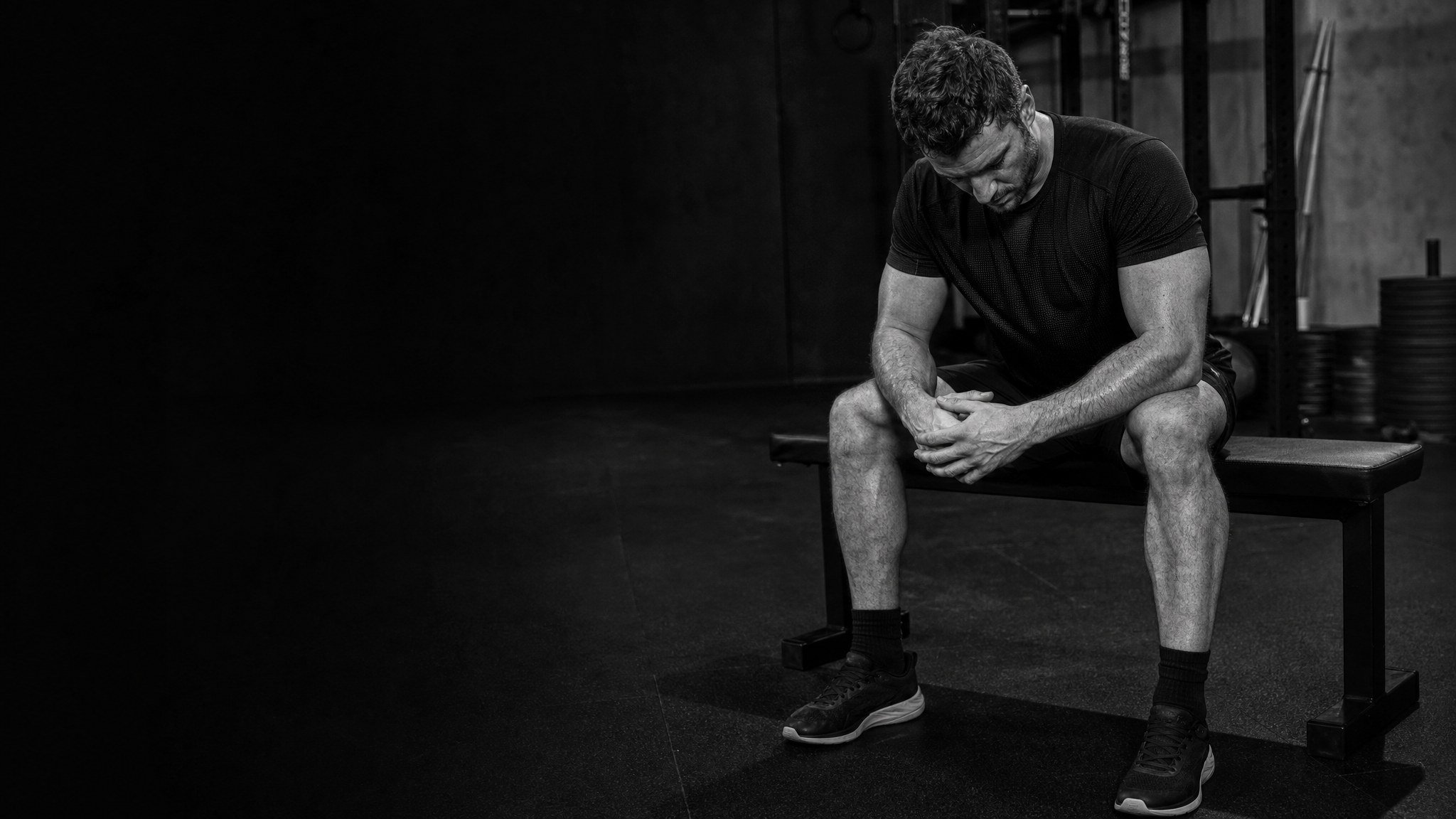 Athlete resting on a bench after a hard gym session