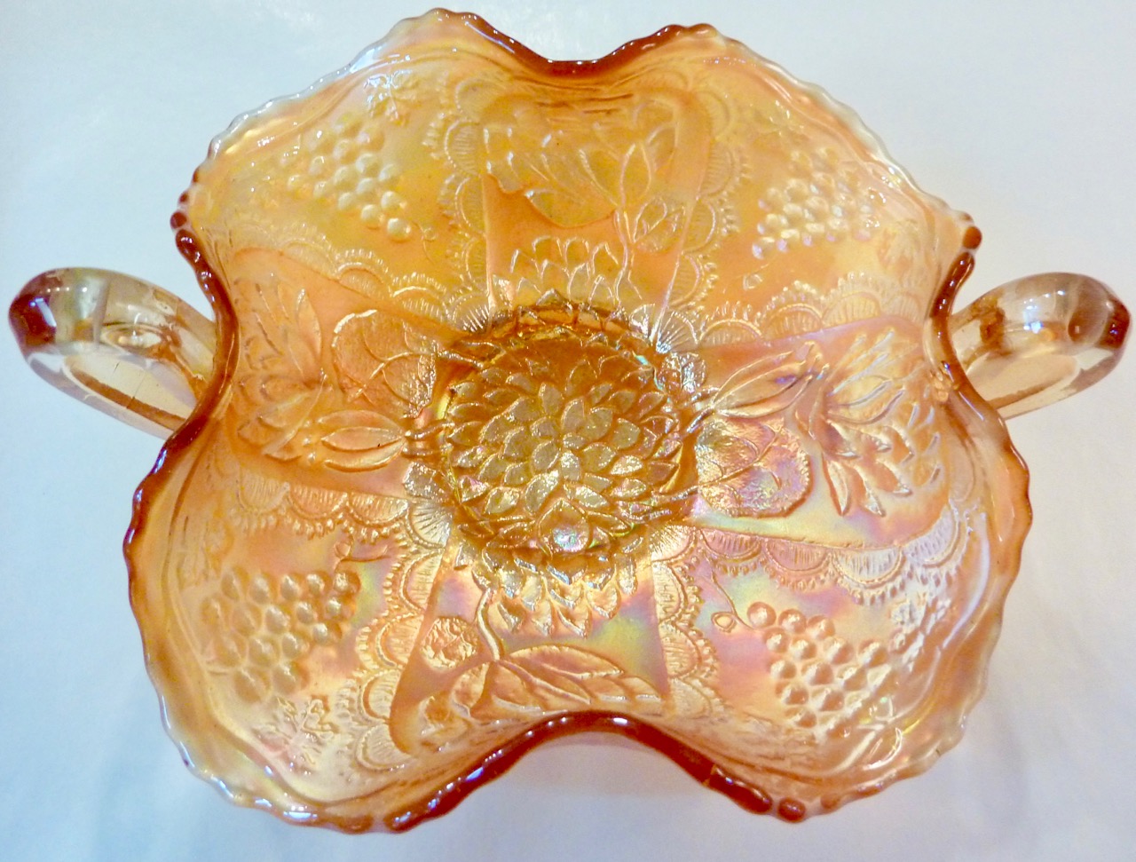 Top view of an iridescent carnival glass bowl with a molded pattern