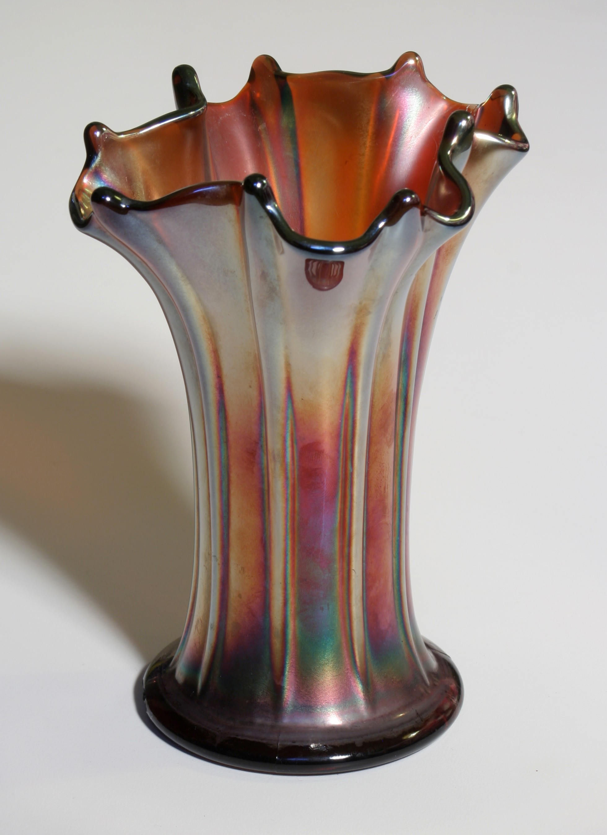 Iridescent carnival glass vase with a flared rim