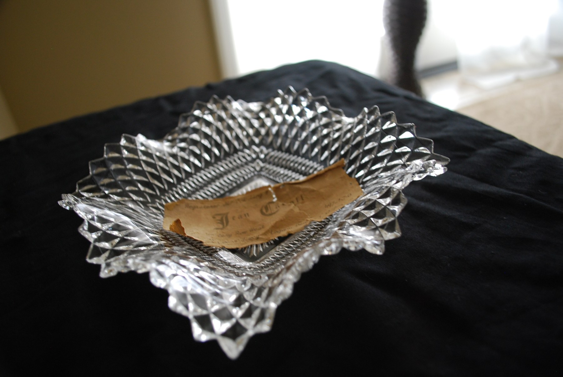 A collection of colorful Depression glass on a shelf