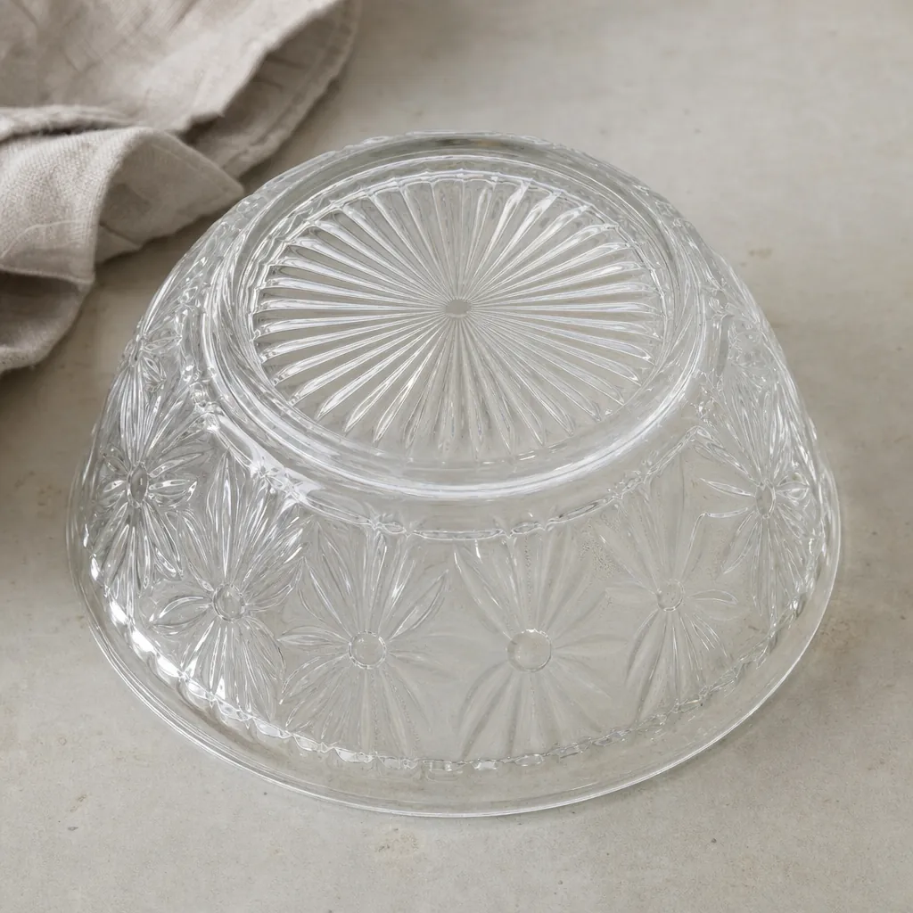 The patterned base of a clear pressed-glass bowl