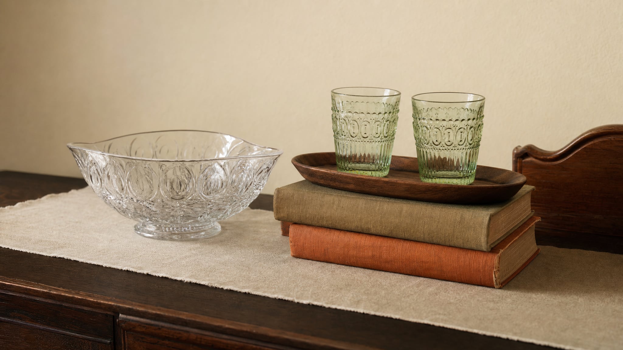 A pressed-glass bowl and green tumblers arranged as a small vintage display