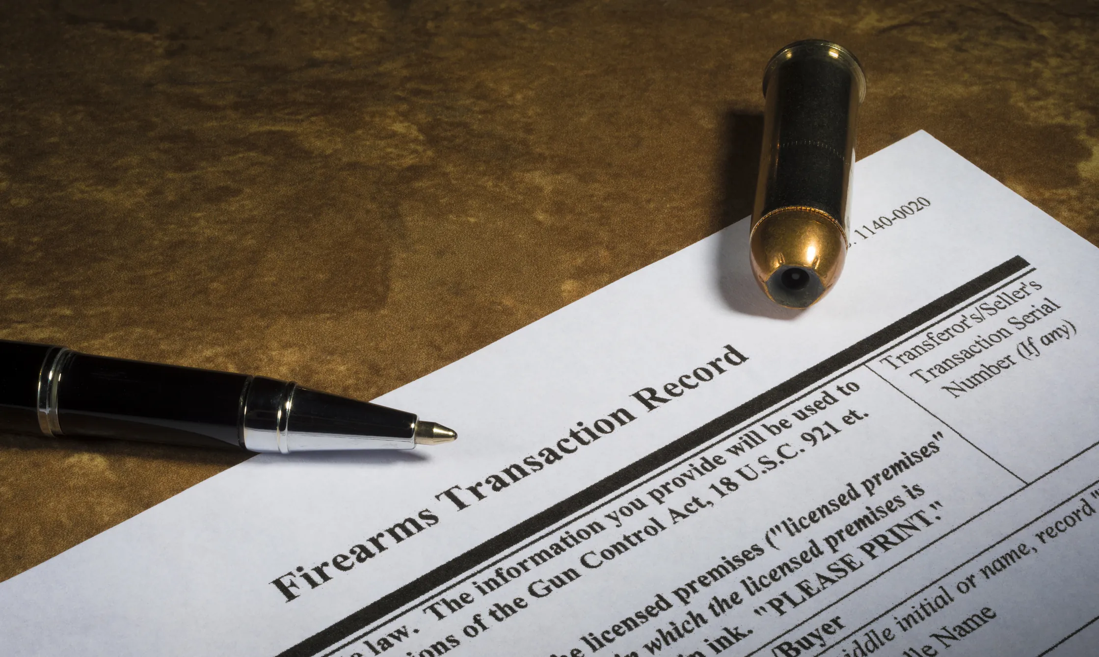 Firearms and paperwork on a gun counter for a Minnesota purchase