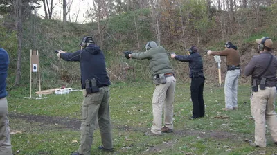 Handgun students training on a safe outdoor range