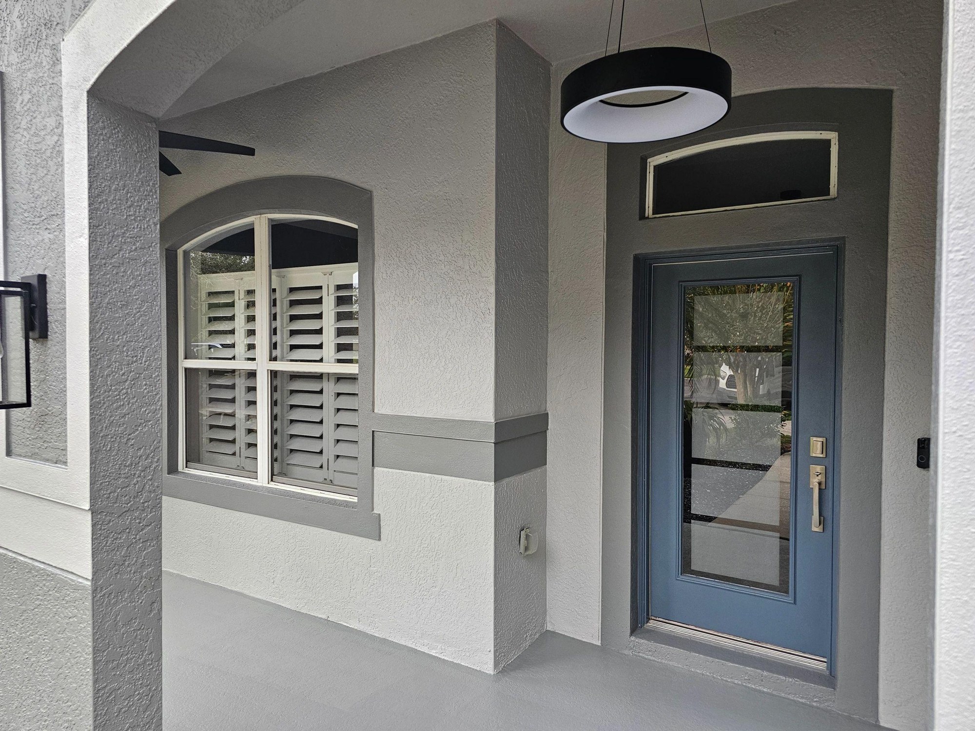 Gray exterior walls, white trim and a blue front door
