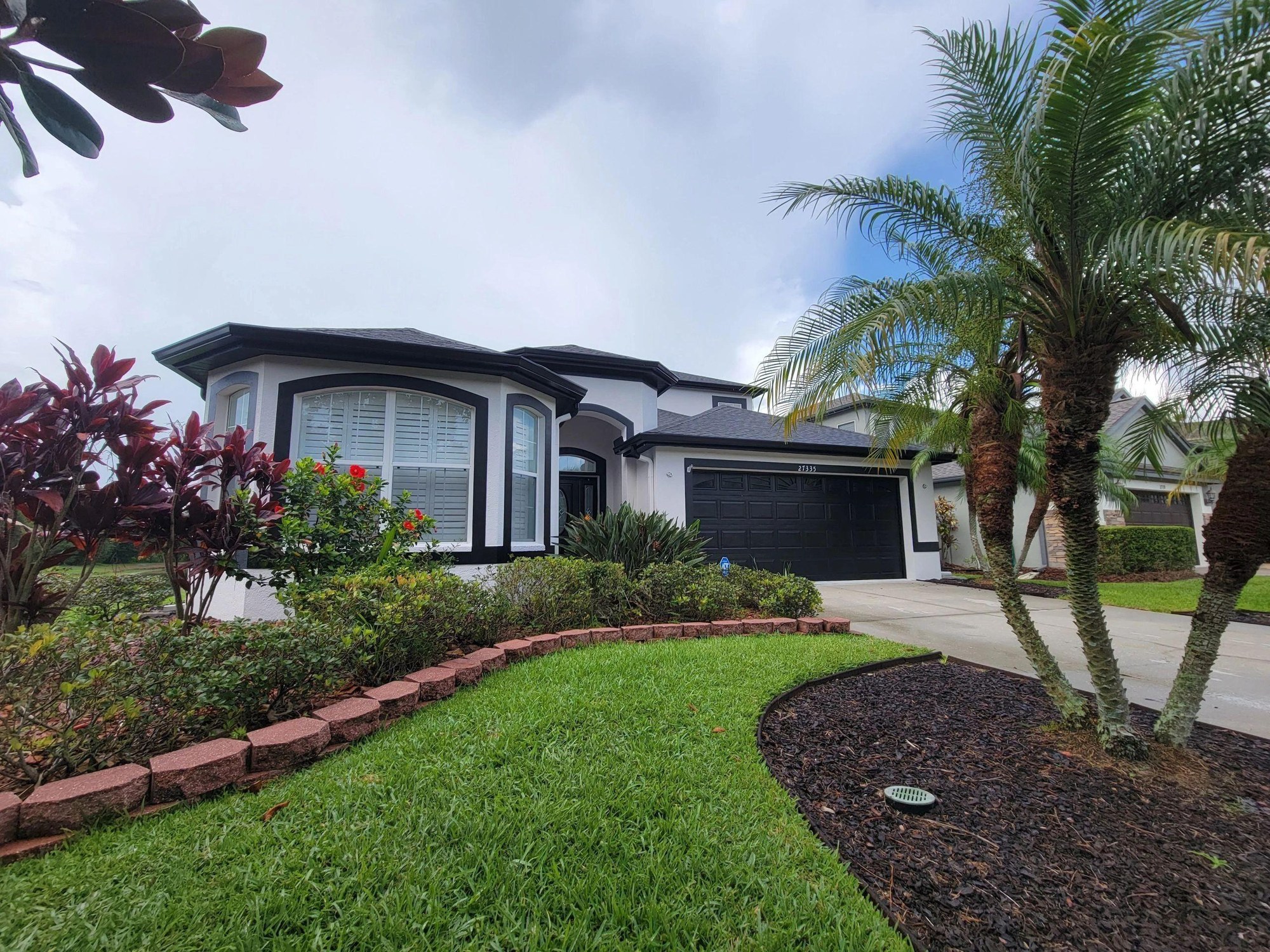 Painted home exterior with a landscaped front yard