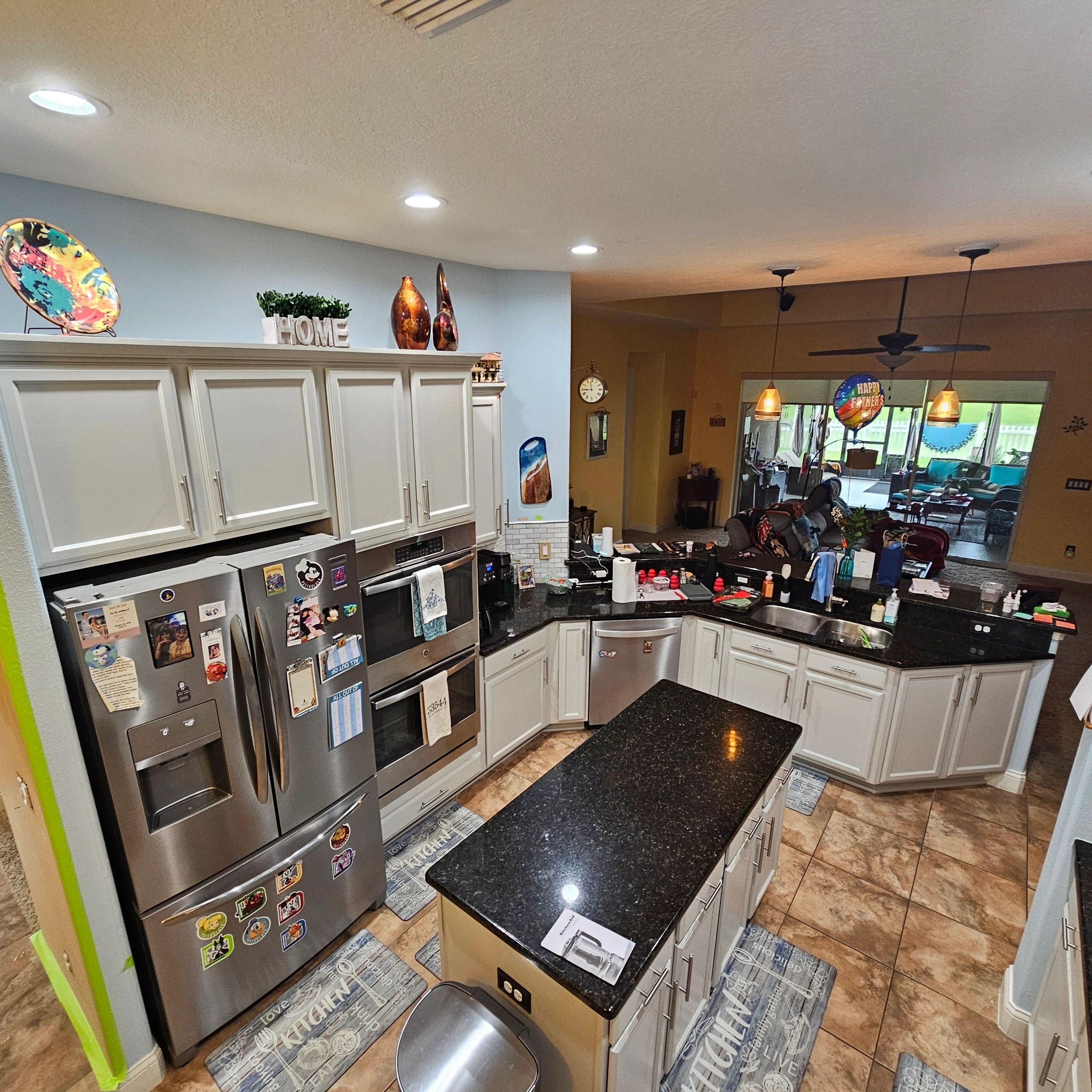Full kitchen cabinet layout with an island and stainless steel appliances