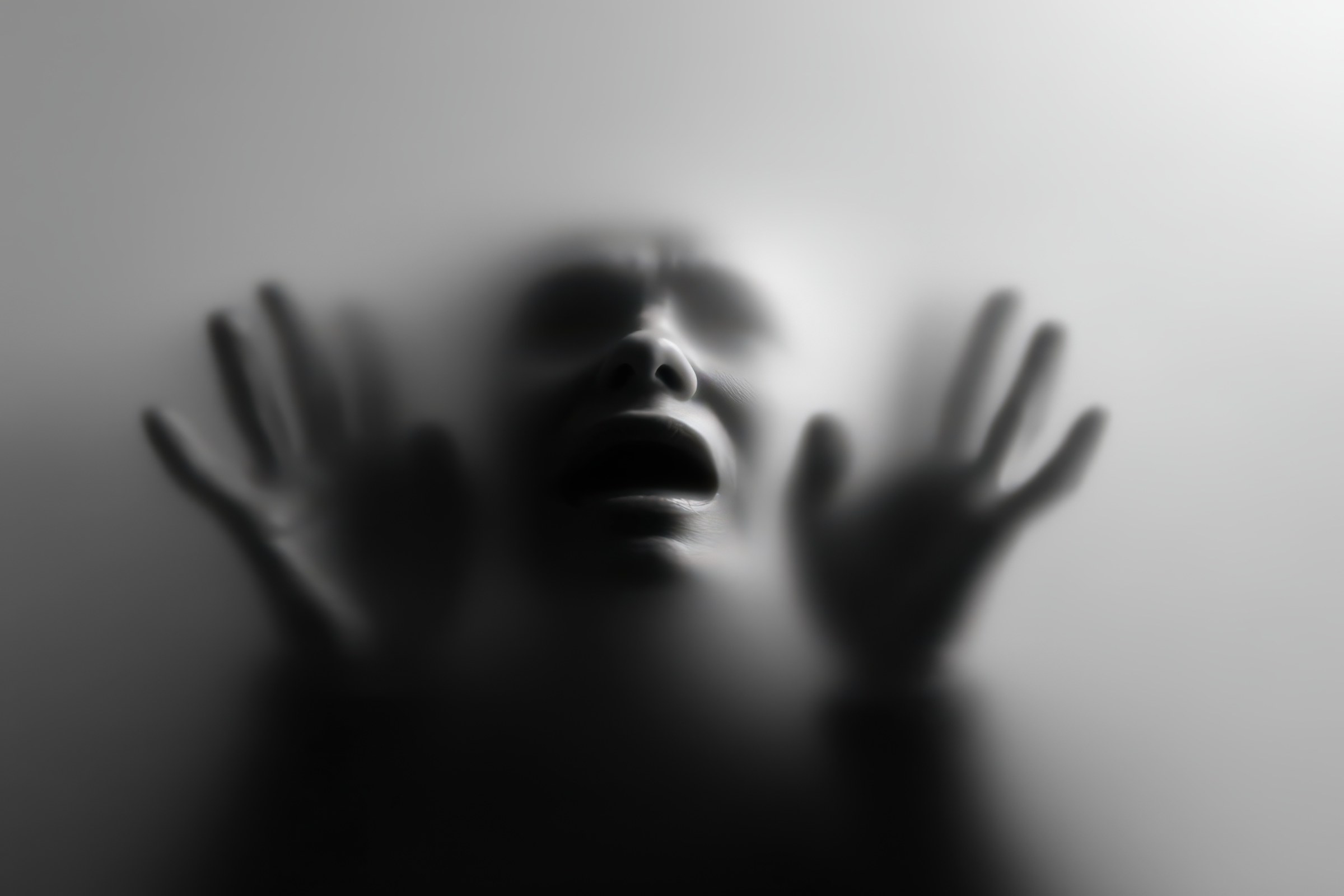 Person behind frosted glass, representing fear and phobias