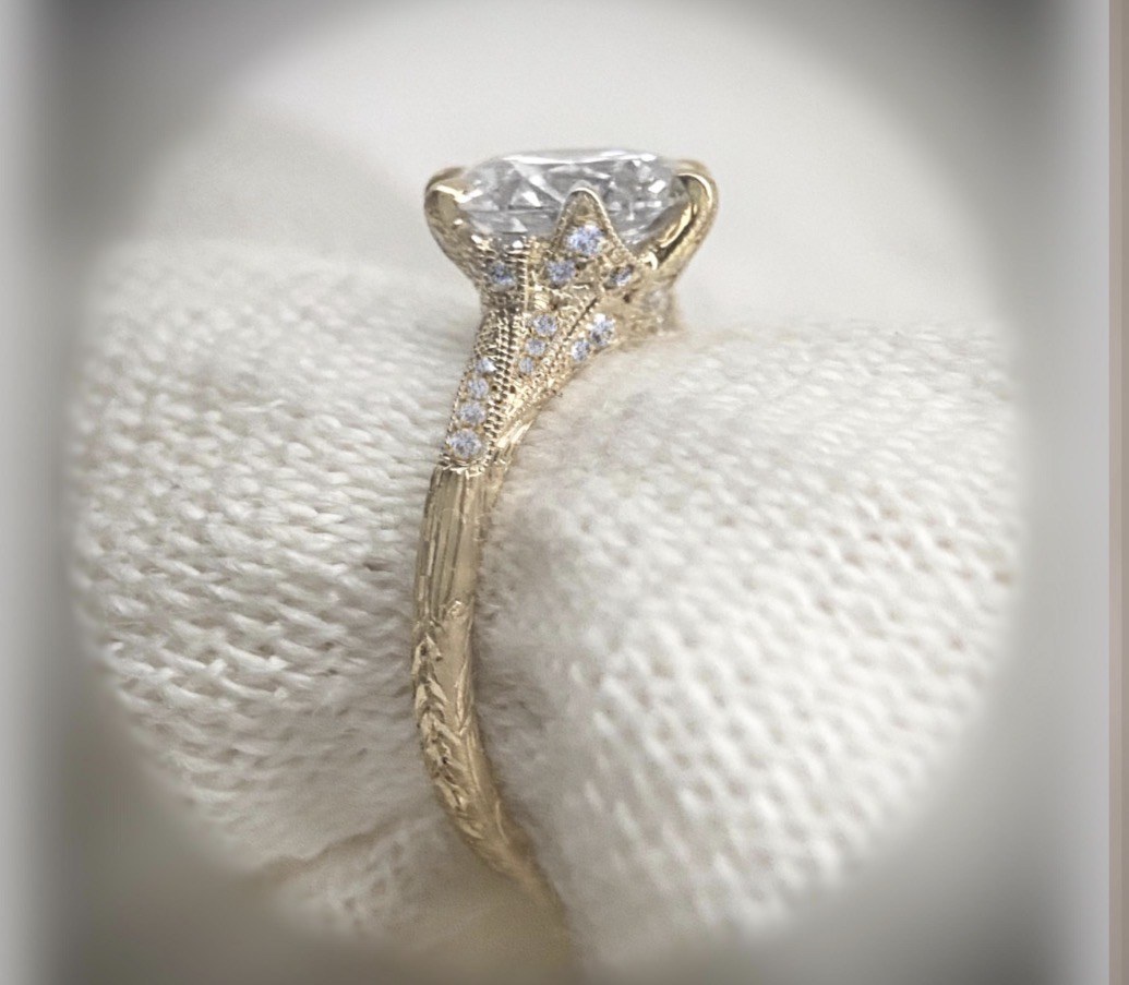 Close-up of a yellow-gold solitaire diamond ring