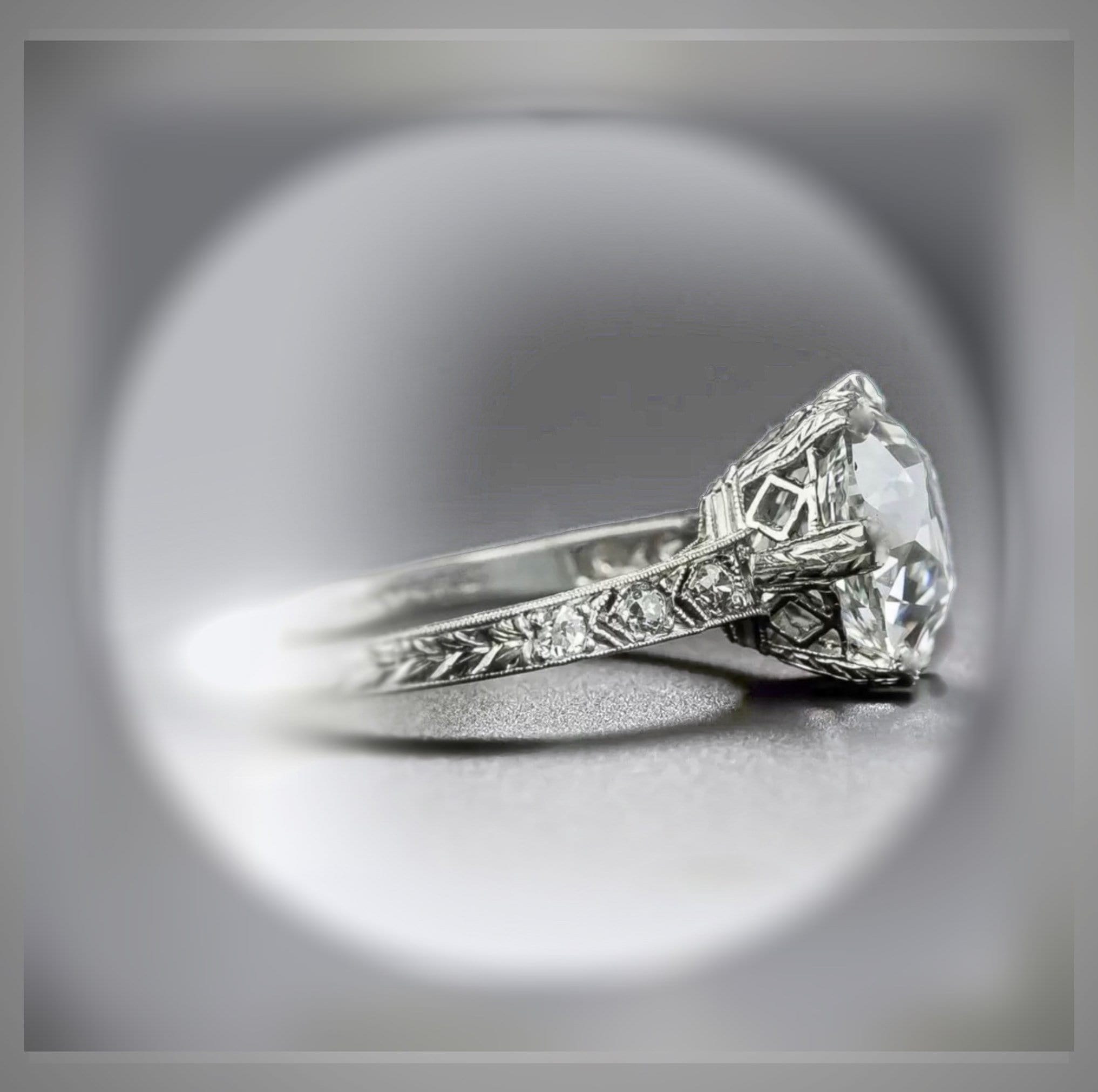Close view of a diamond ring with a warm antique-inspired setting