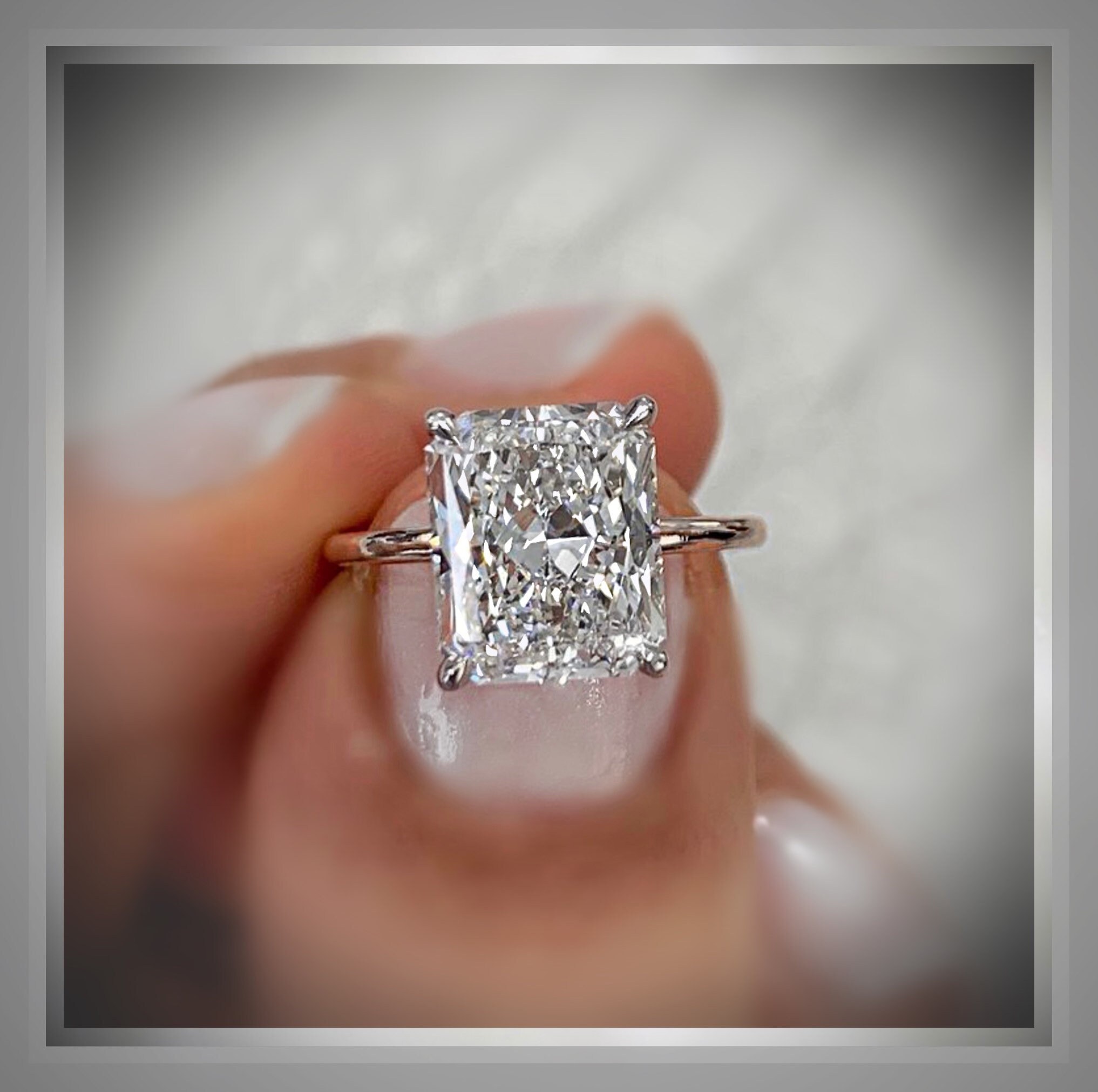 Antique-inspired engagement ring with a protective low-set diamond surround
