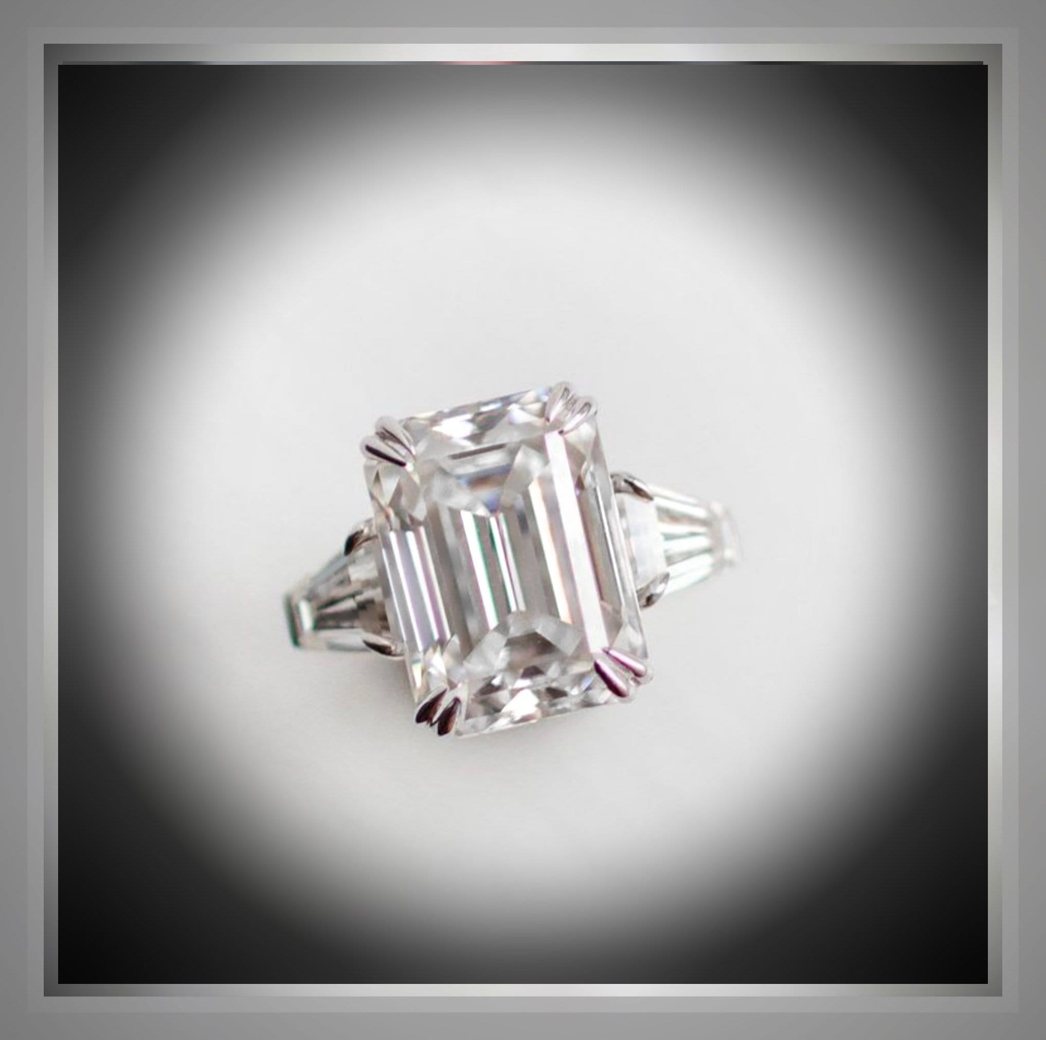 Emerald-cut diamond engagement ring with tapered baguette side stones