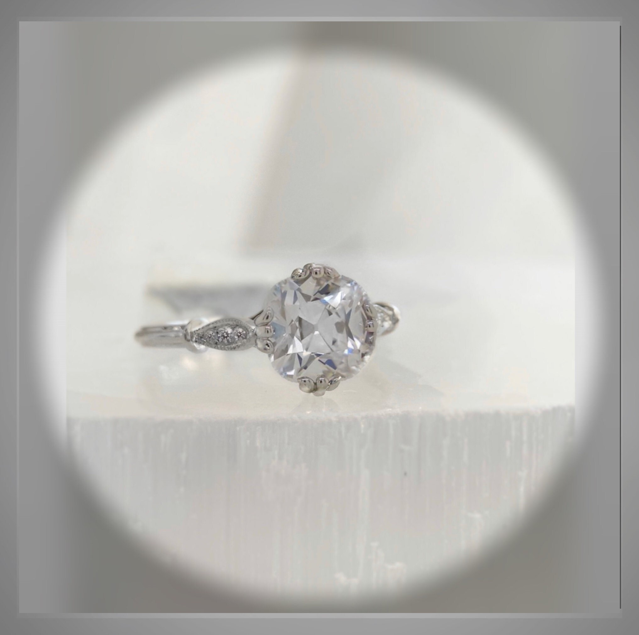 Close view of an antique-inspired cushion-shaped diamond ring