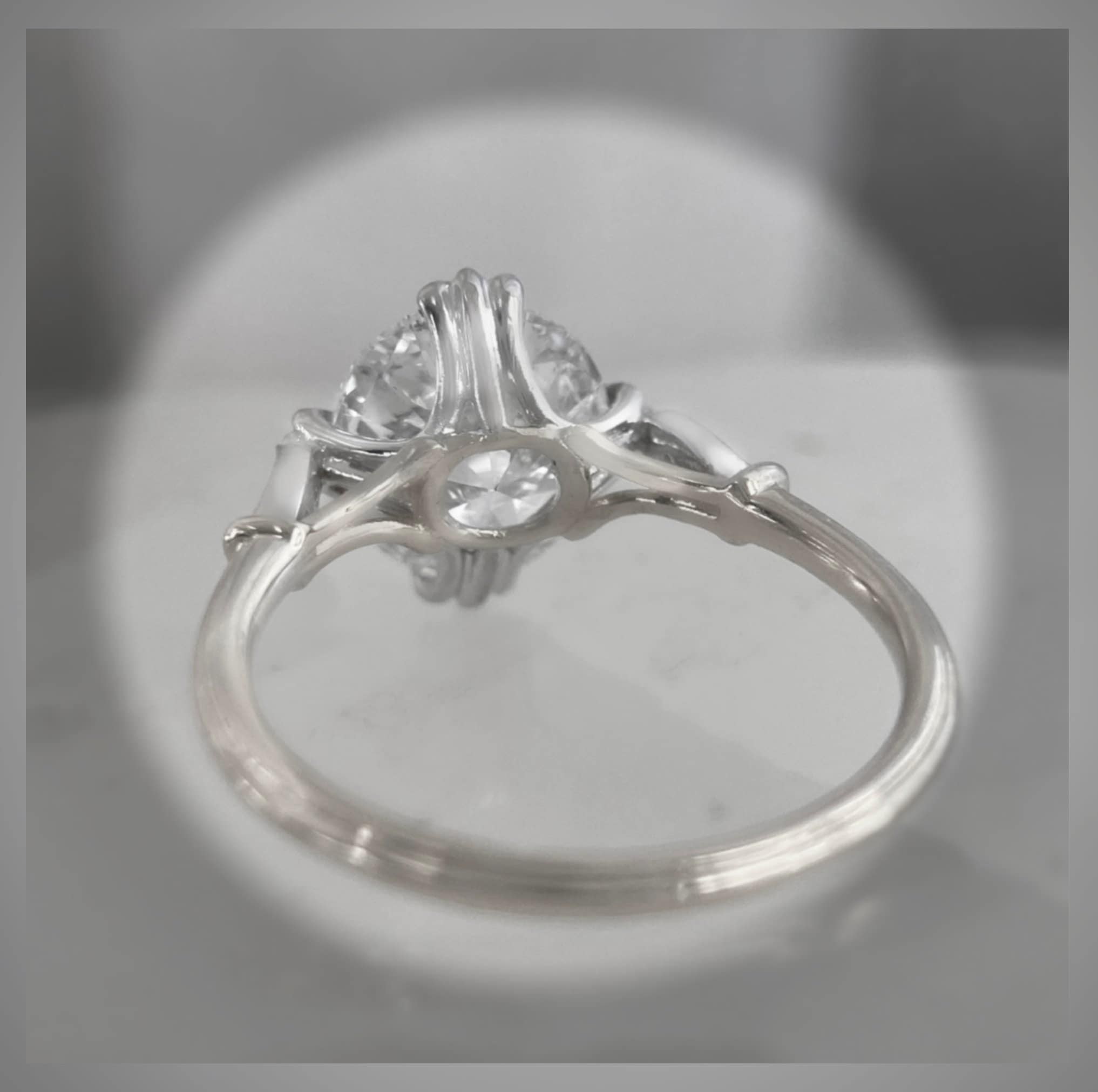 Side view of an antique-inspired diamond ring with detailed setting