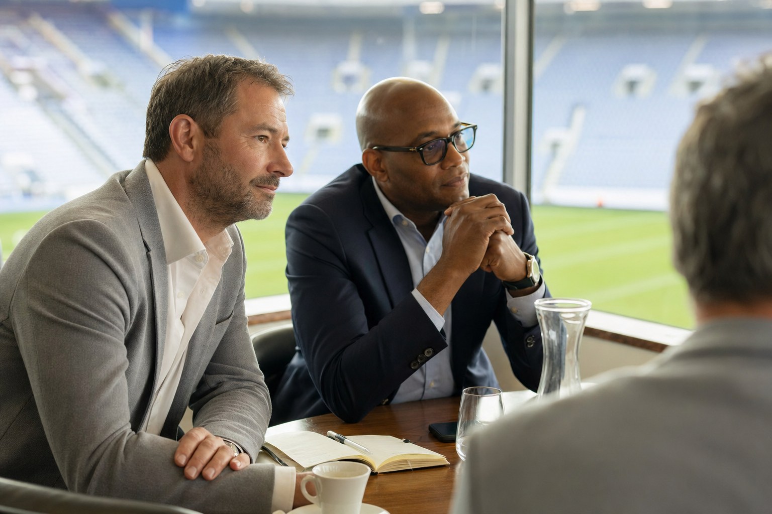 Business leaders listening carefully during a small stadium roundtable