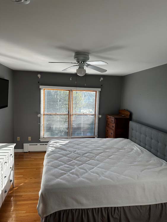 Bedroom with warm gray painted walls and natural light