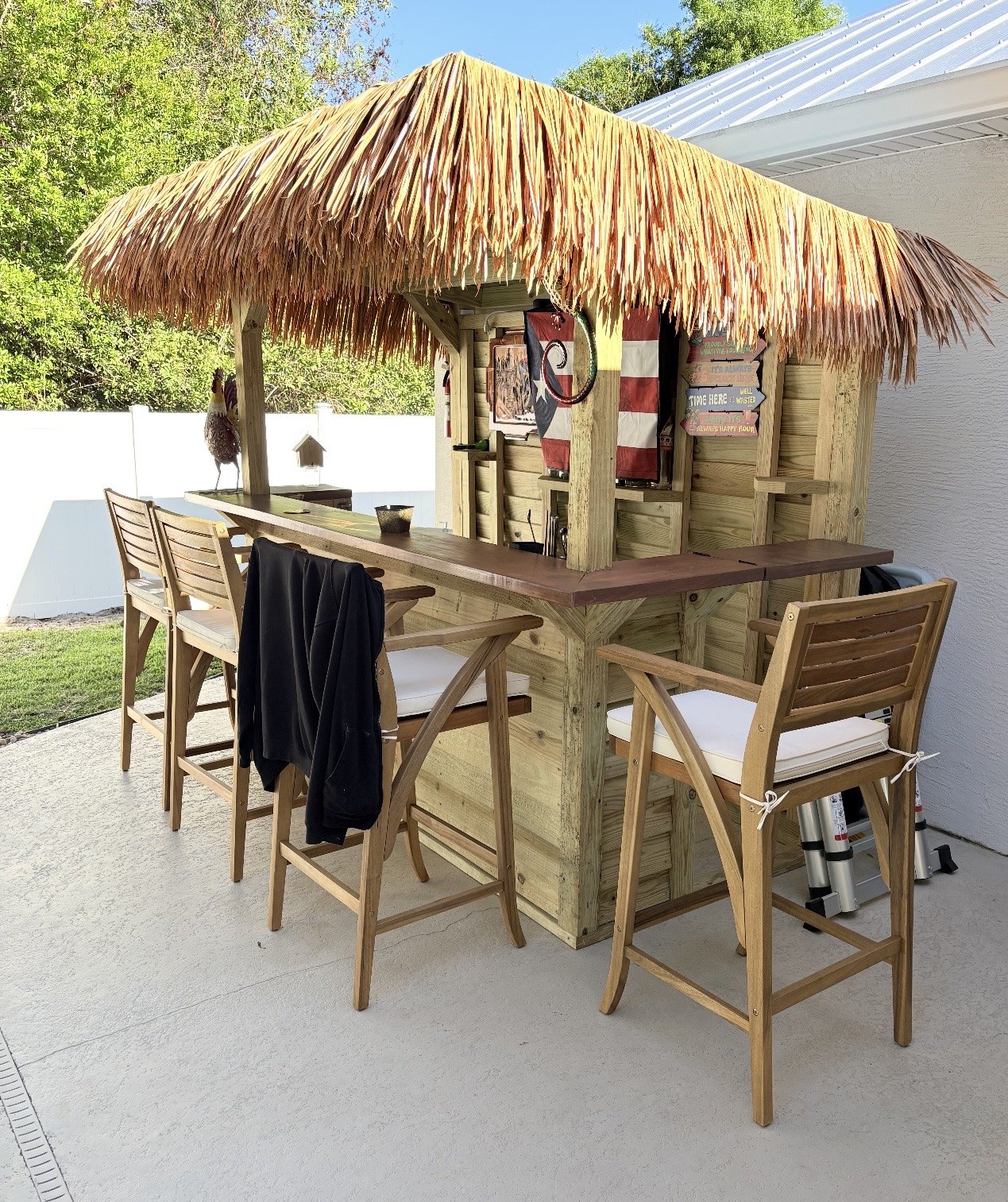 Tiki-style backyard bar with thatched roof