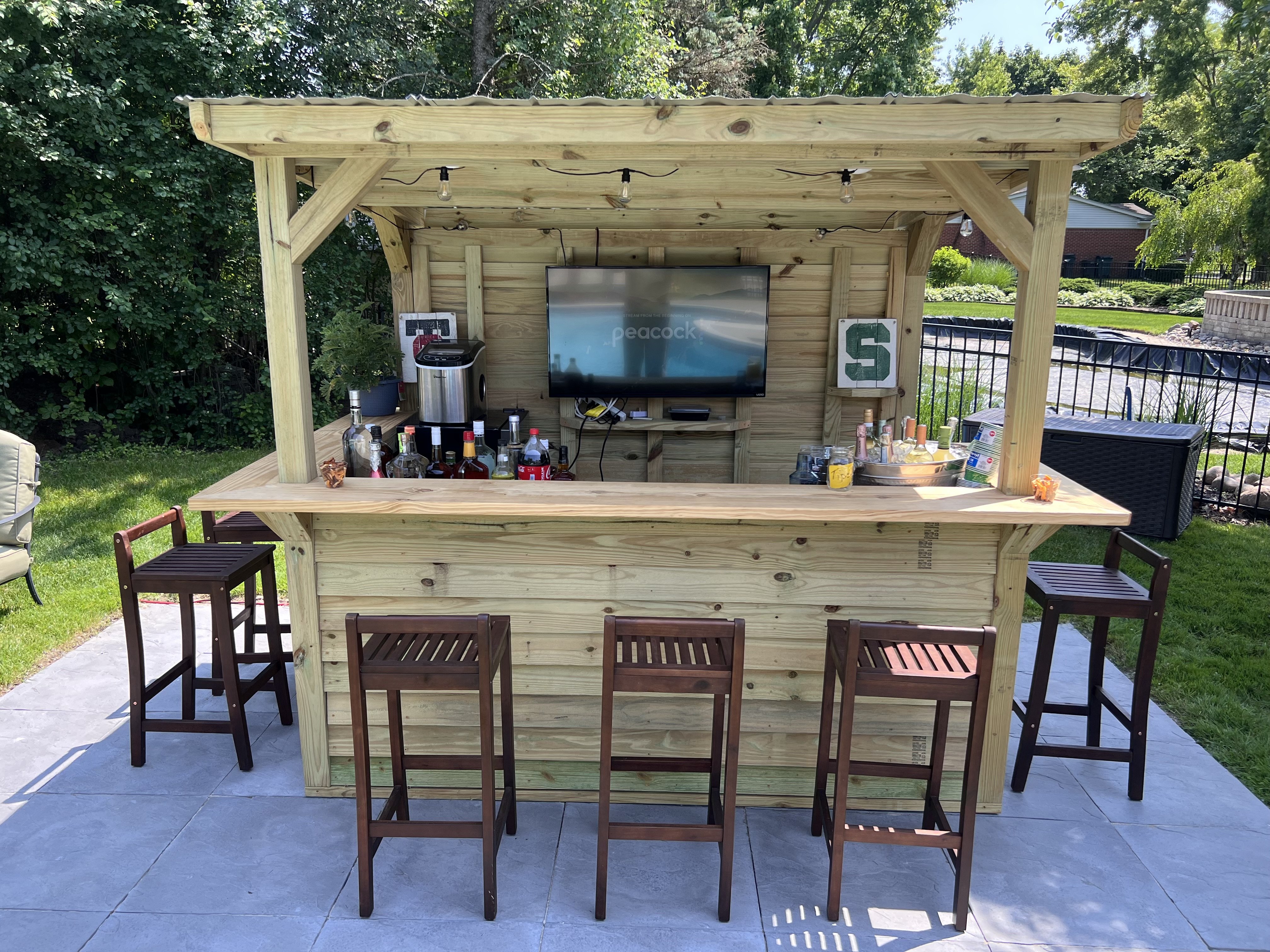 Backyard bar with television and seating