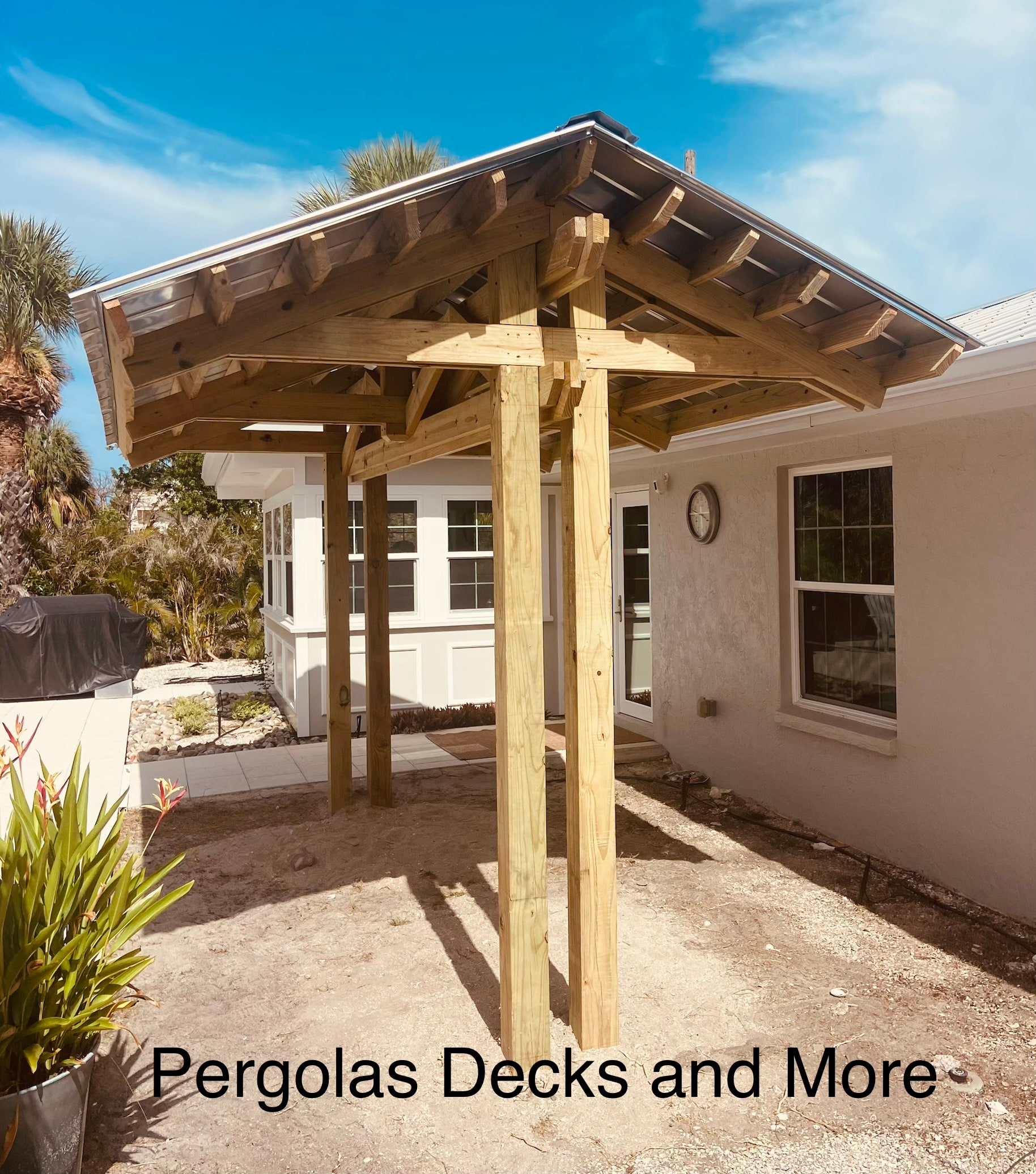 Custom wood gazebo structure beside a home