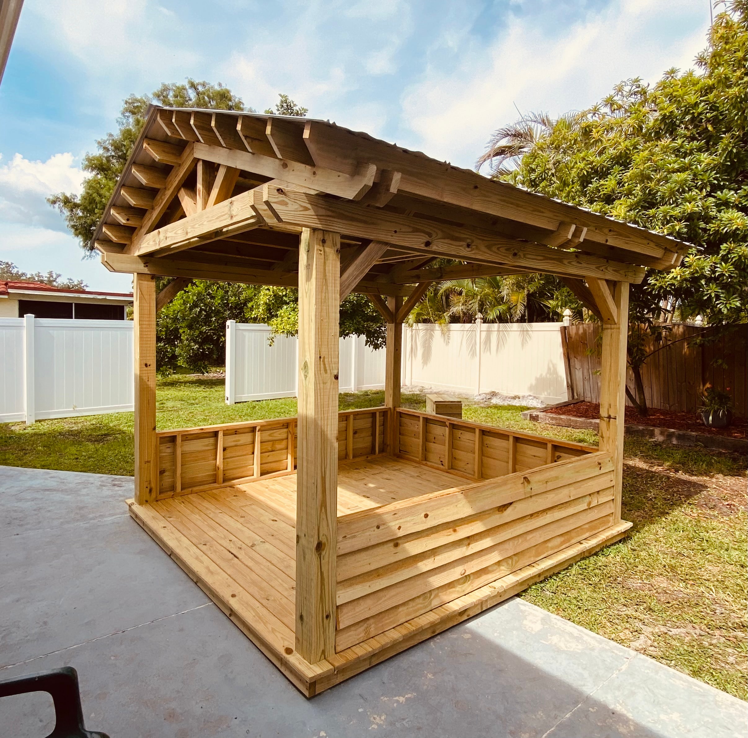 Custom wood grill hut with an open front and covered cooking area