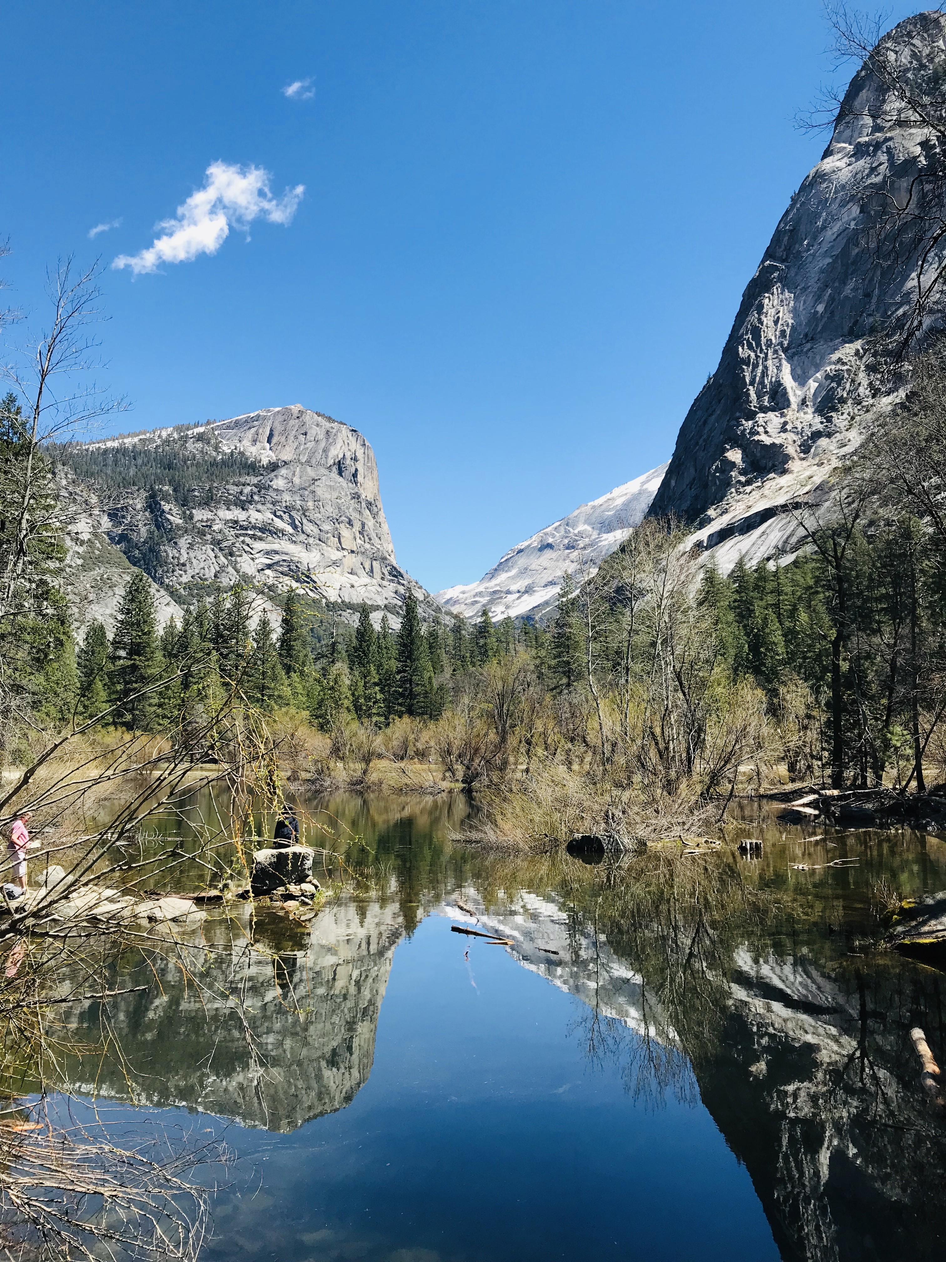 Mirror Lake reflecting Yosemite cliffs and a bright blue sky