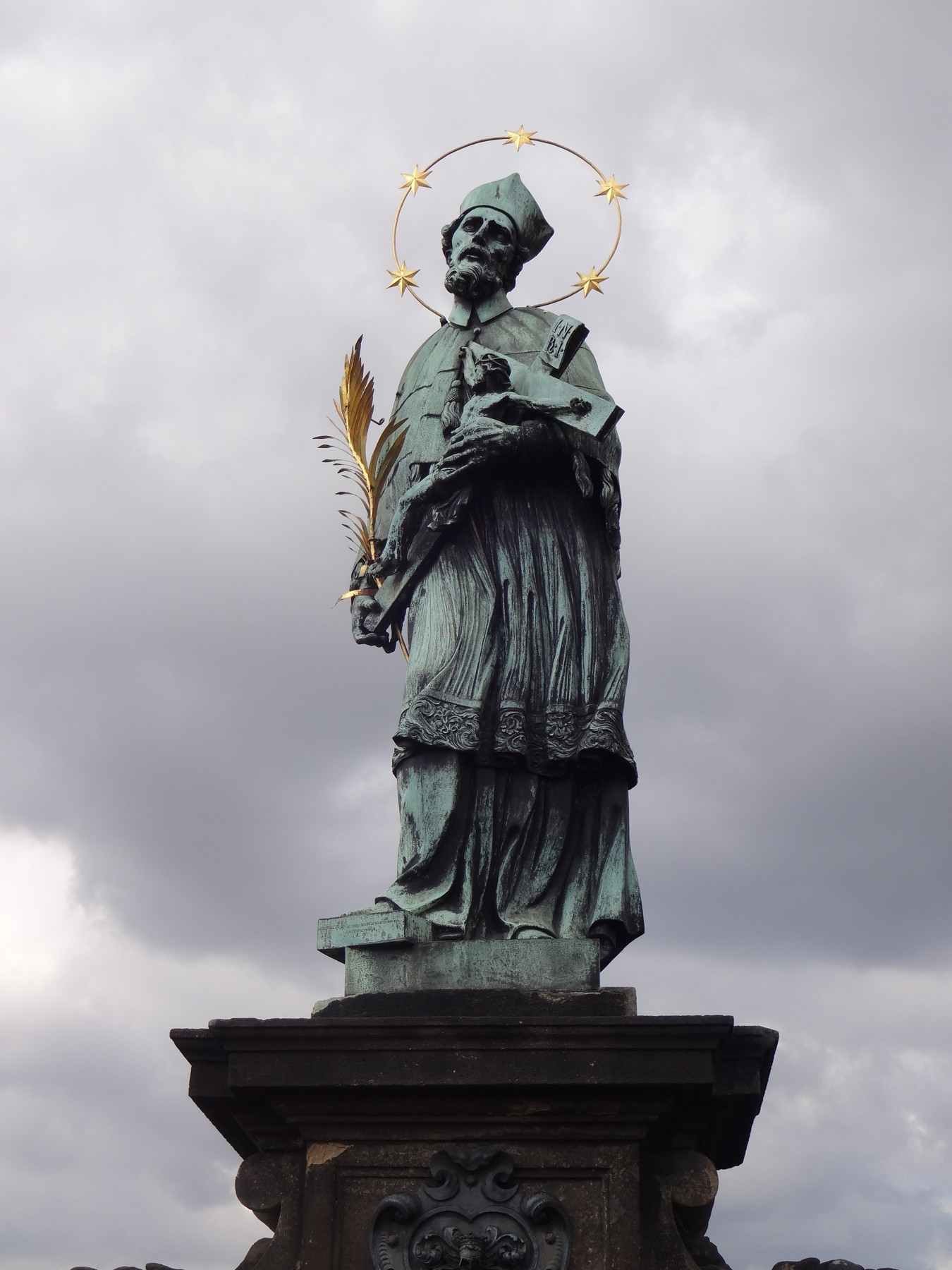 The statue of St. John of Nepomuk with its five-star halo on Charles Bridge.