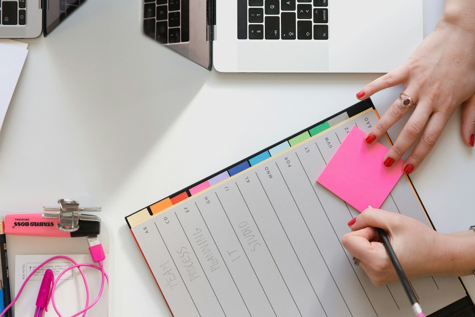 Business owner using a weekly planning board at a desk