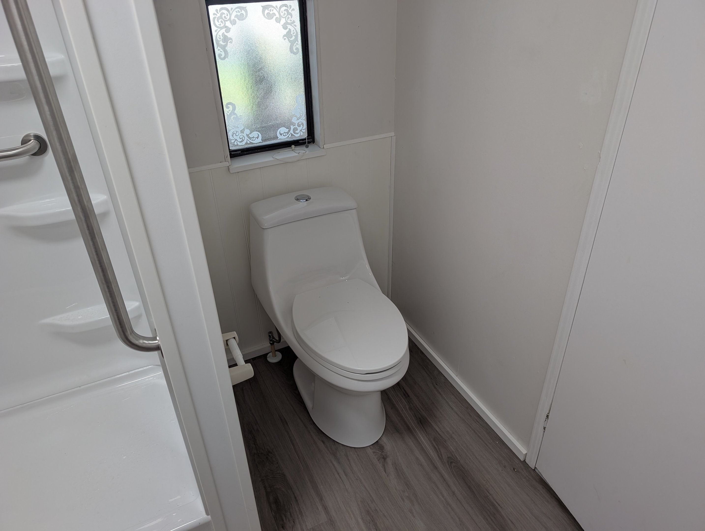 One-piece toilet installation with wall surround