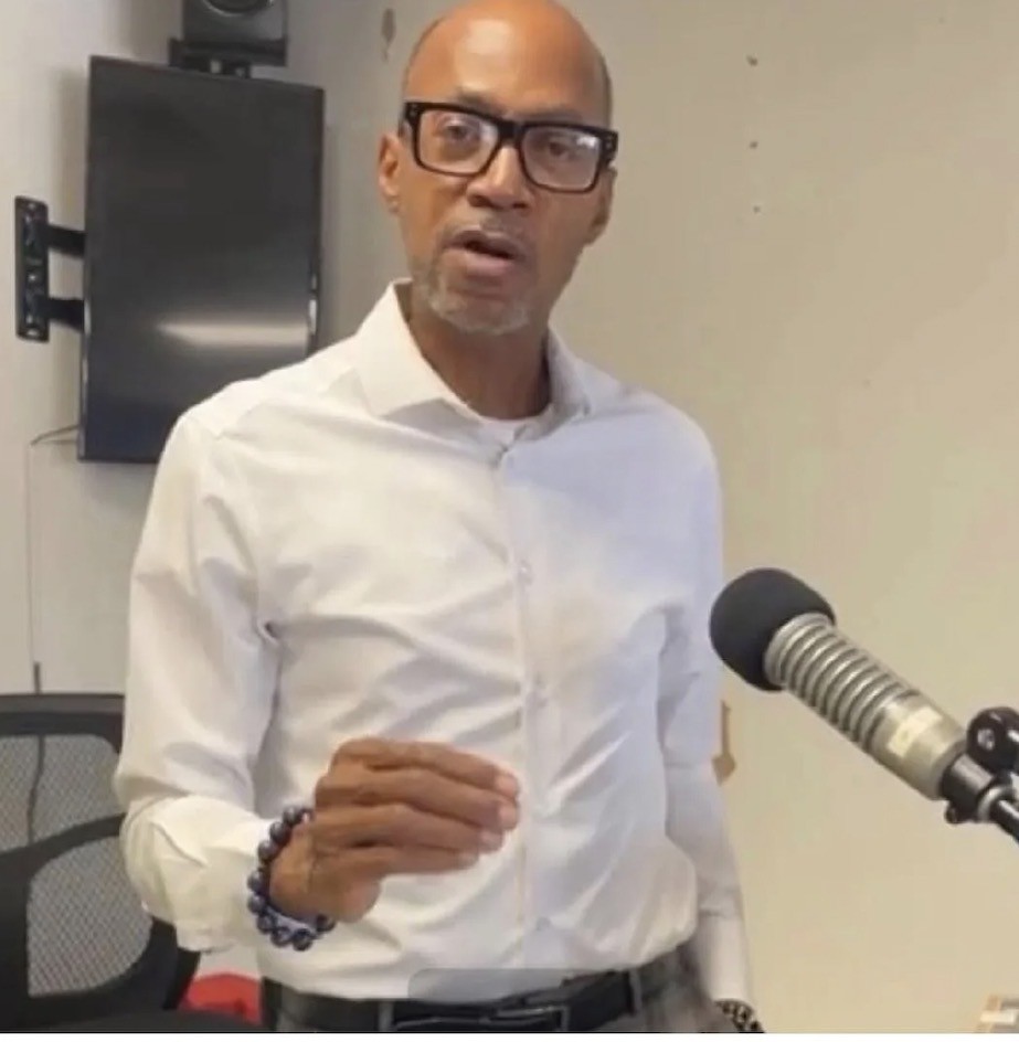 Dr. Arthur L. Hunt, Jr. speaking beside a microphone